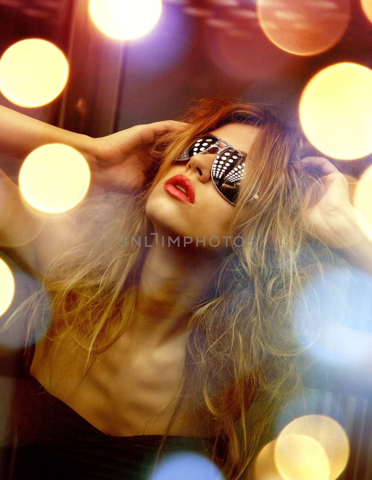 beautiful woman in sunglasses in elevator by dolgachov