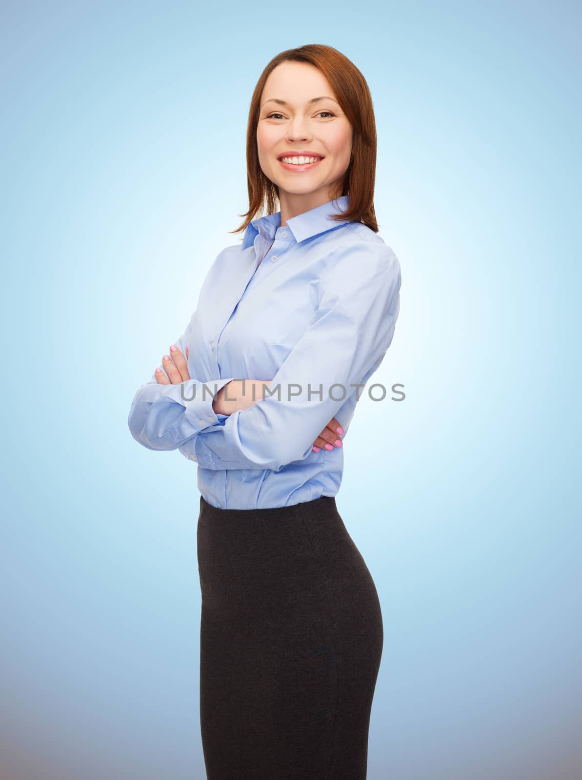 business, people and education concept - smiling young businesswoman with crossed arms over blue background