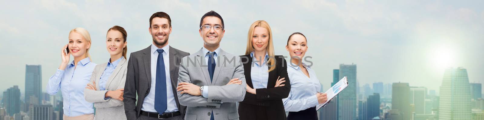 business, people, gesture and office concept - group of smiling businessmen over city background