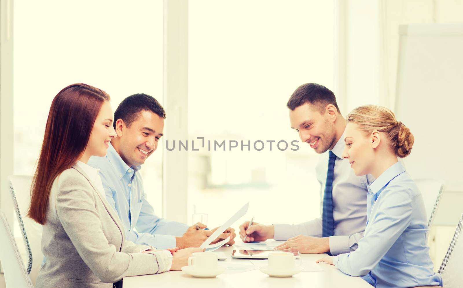 business and office concept - smiling business team having meeting in office