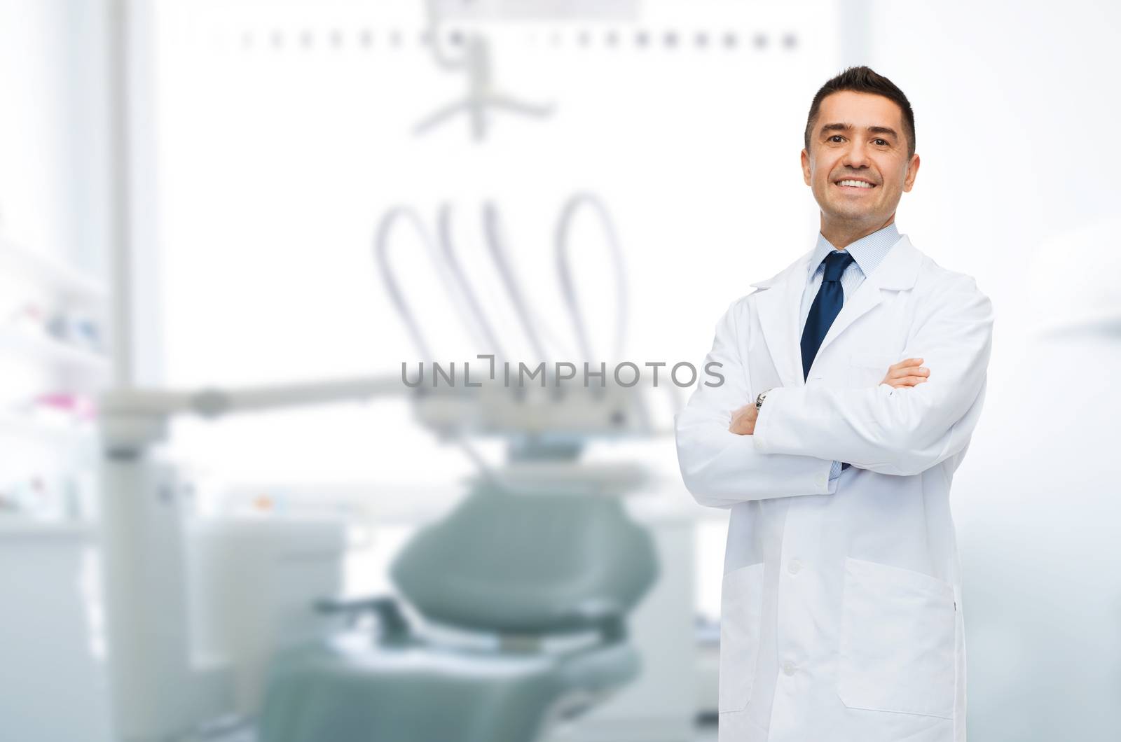 smiling male middle aged dentist by dolgachov