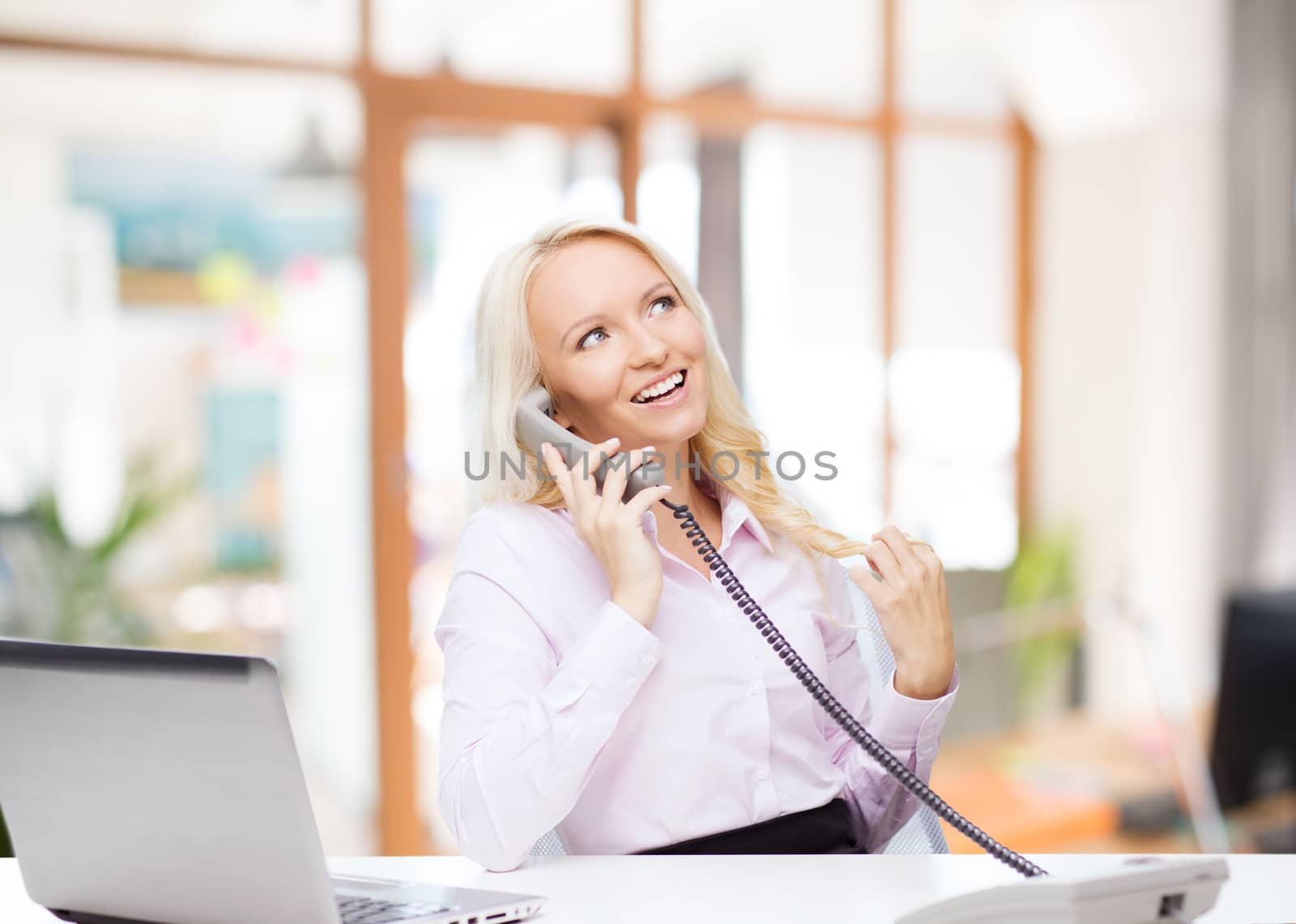 education, business, communication and technology concept - smiling businesswoman or student with laptop computer calling on phone over office room background