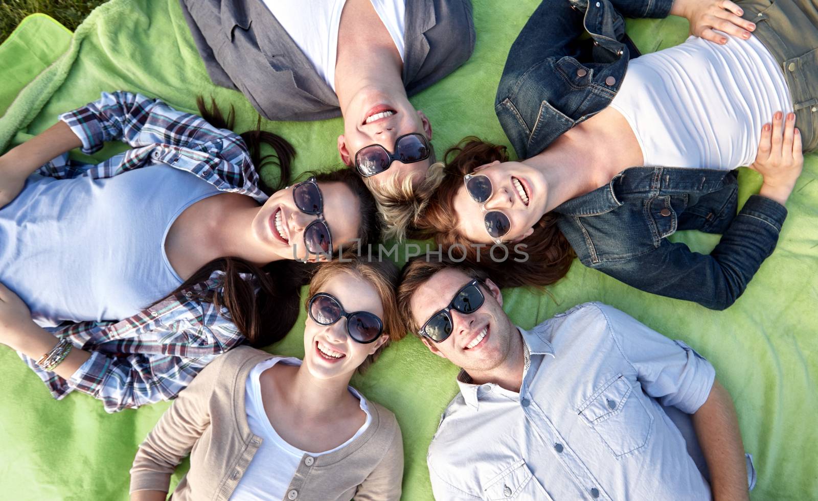 group of students or teenagers lying in circle by dolgachov