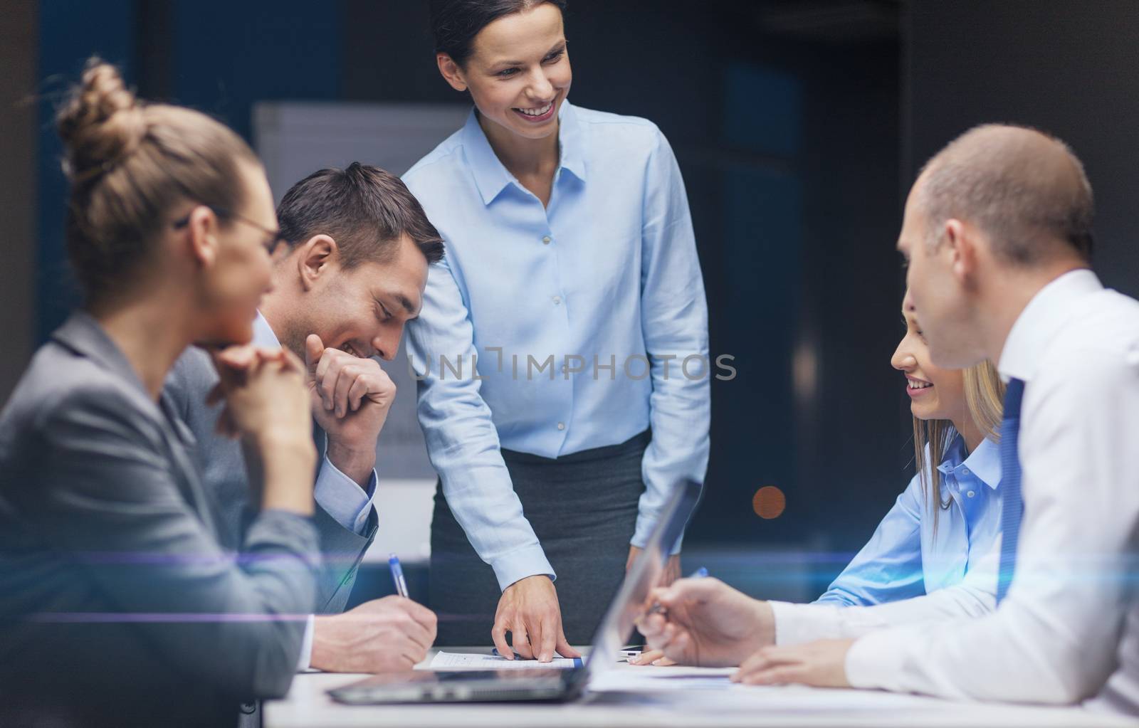 business, technology, management and people concept - smiling female boss talking to business team in office