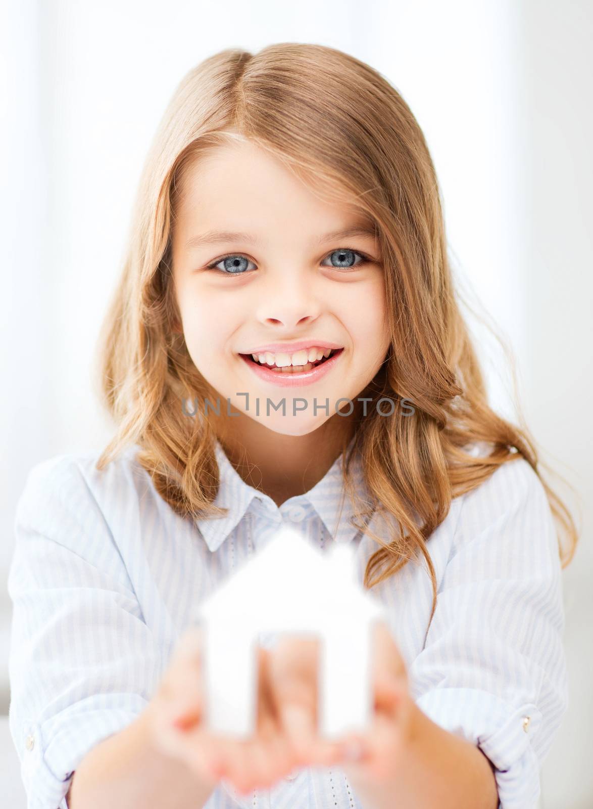 girl holding white paper house by dolgachov