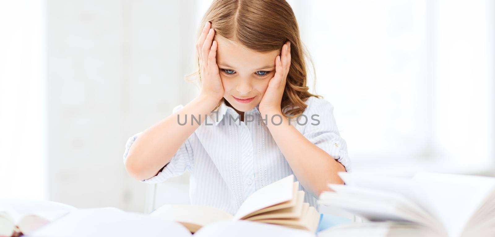 education and school concept - little student girl with many books at school
