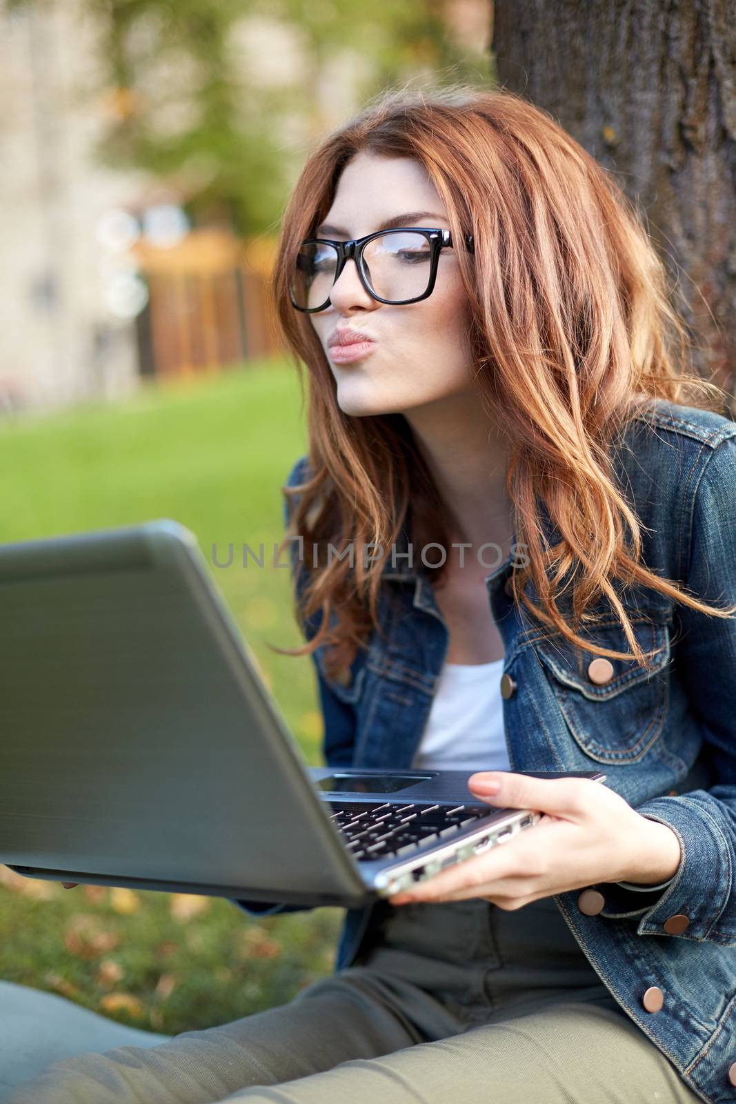 happy student girl writing to notebook at campus by dolgachov