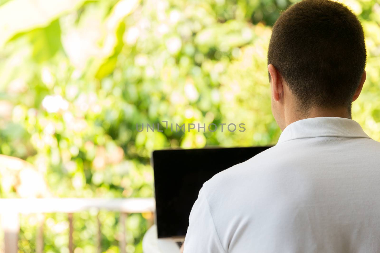 business, people and technology concept - close up of businessman with laptop working outdoors on summer terrace