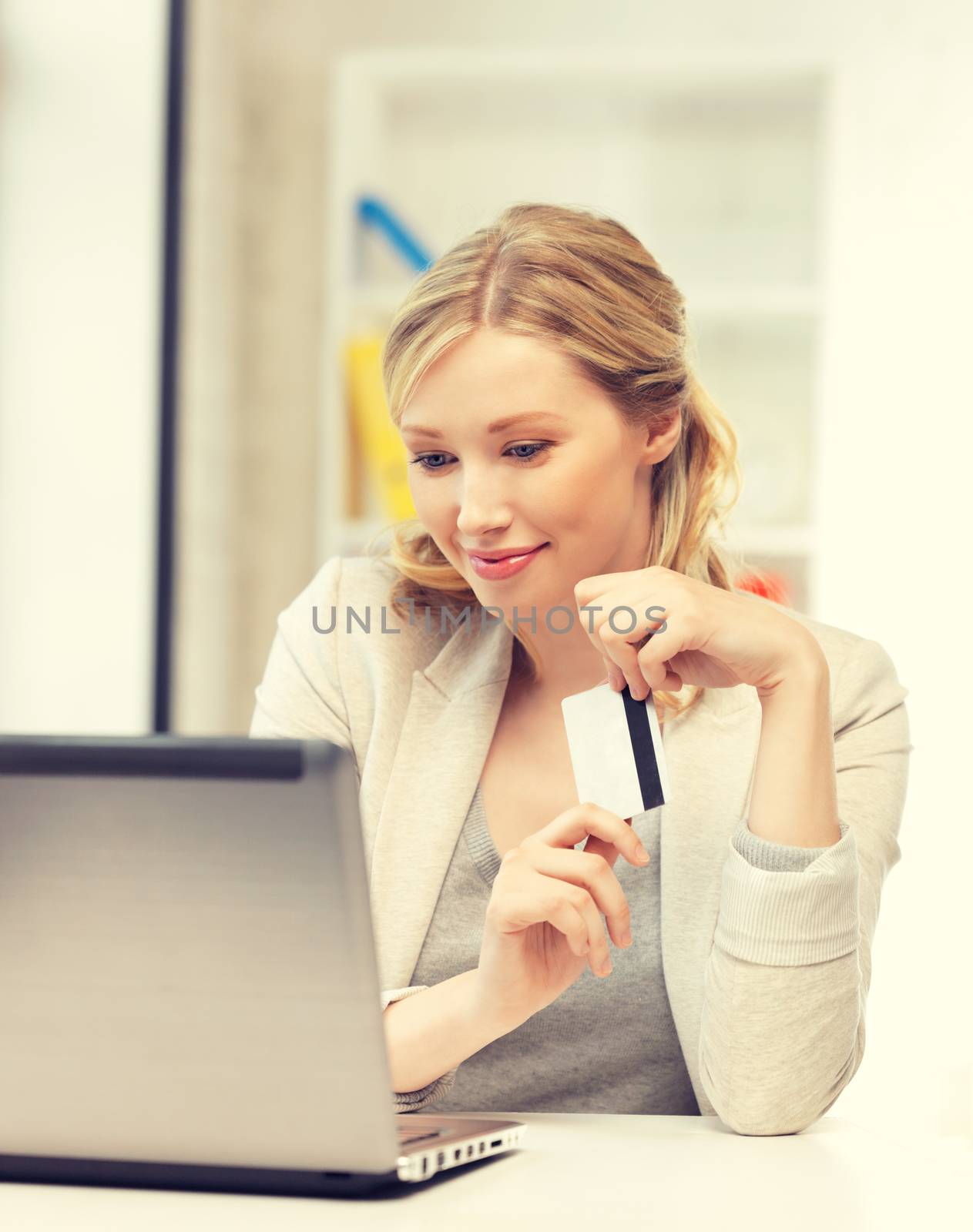 happy woman with laptop computer and credit card by dolgachov