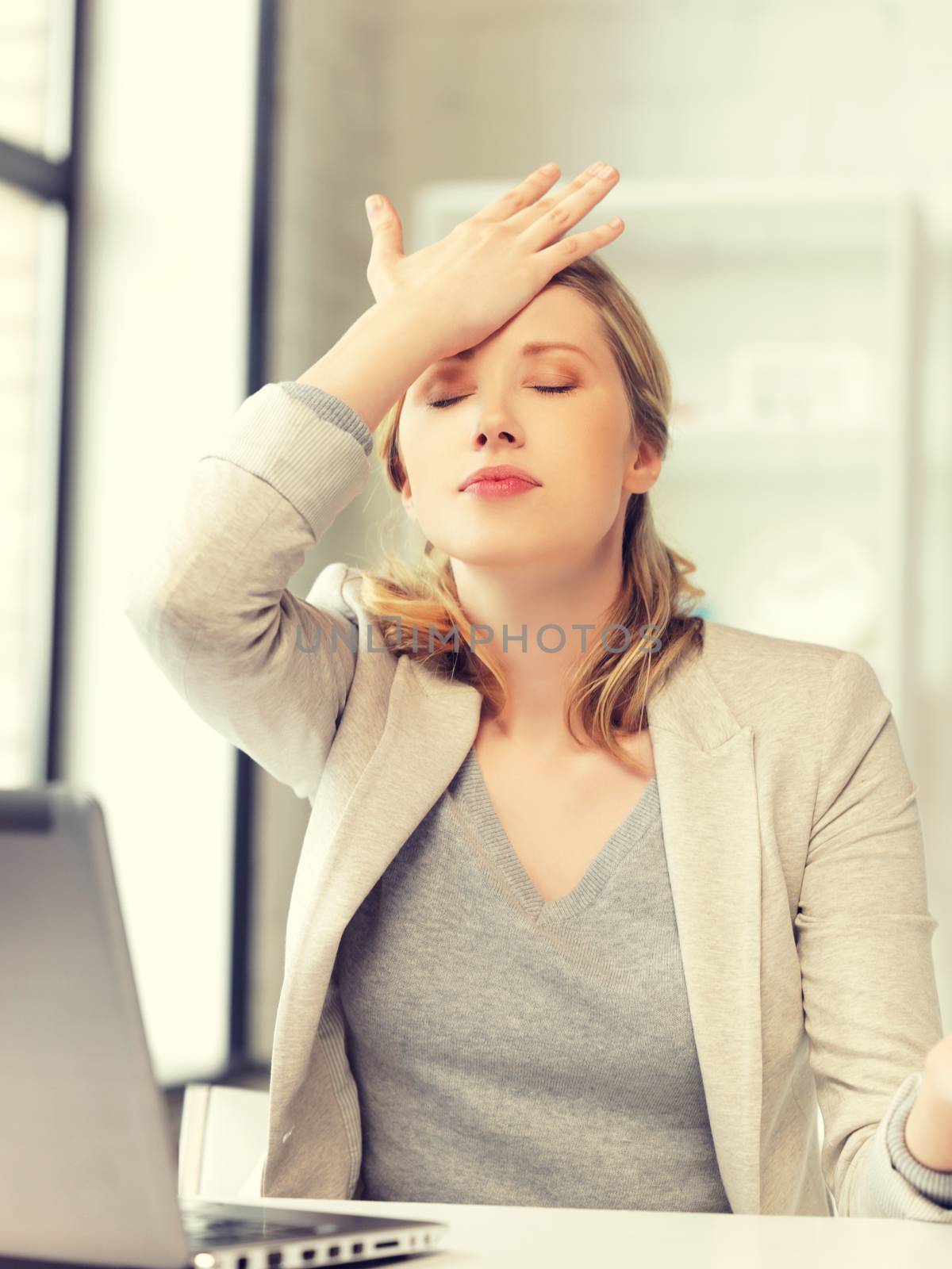 stressed woman with laptop computer by dolgachov