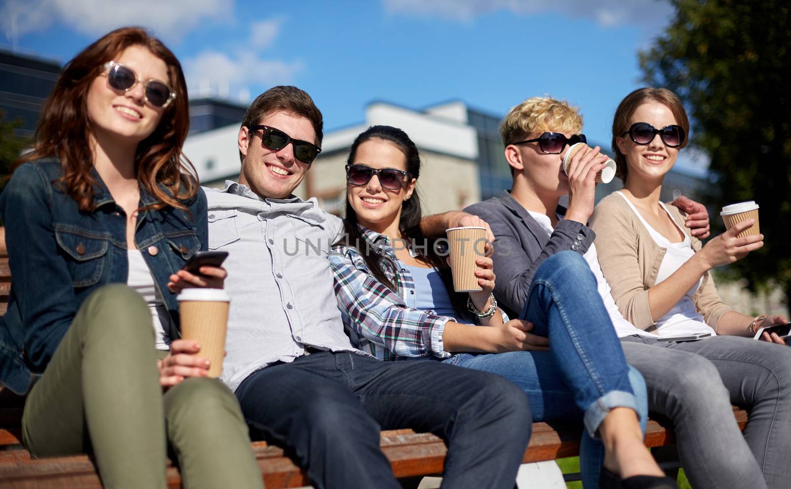 group of students or teenagers drinking coffee by dolgachov