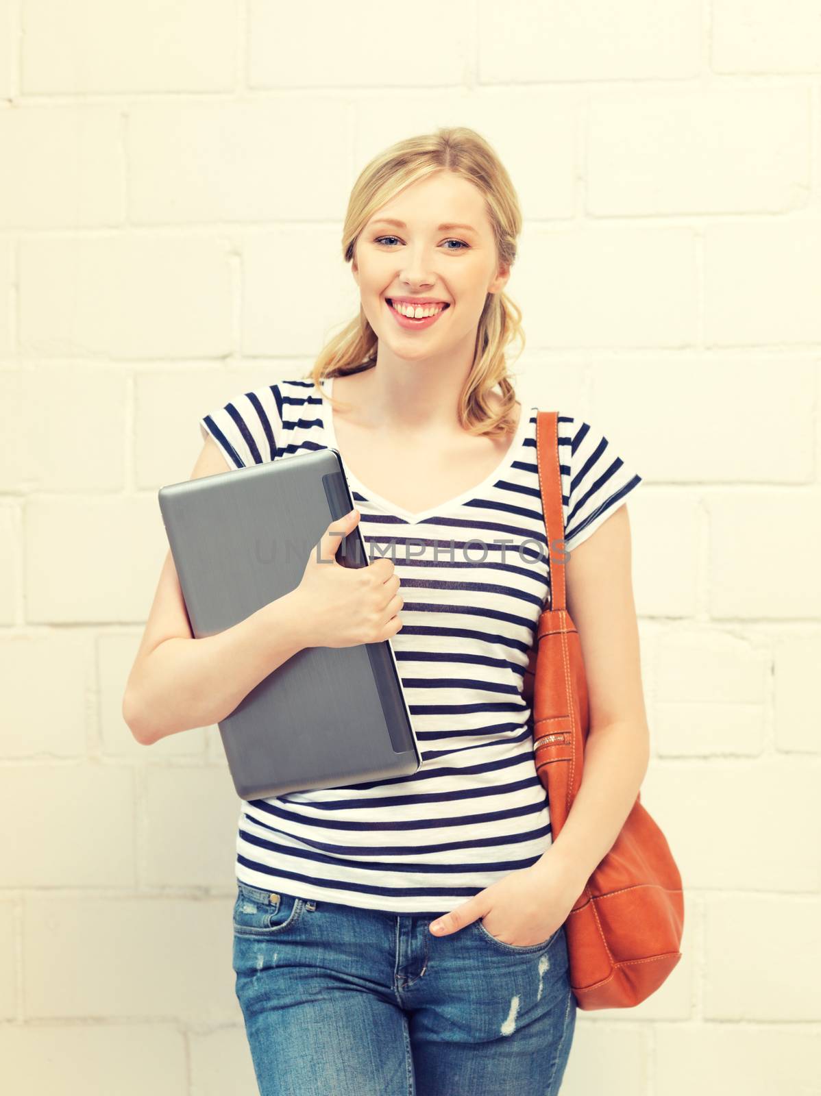 happy and smiling teenage girl with laptop by dolgachov