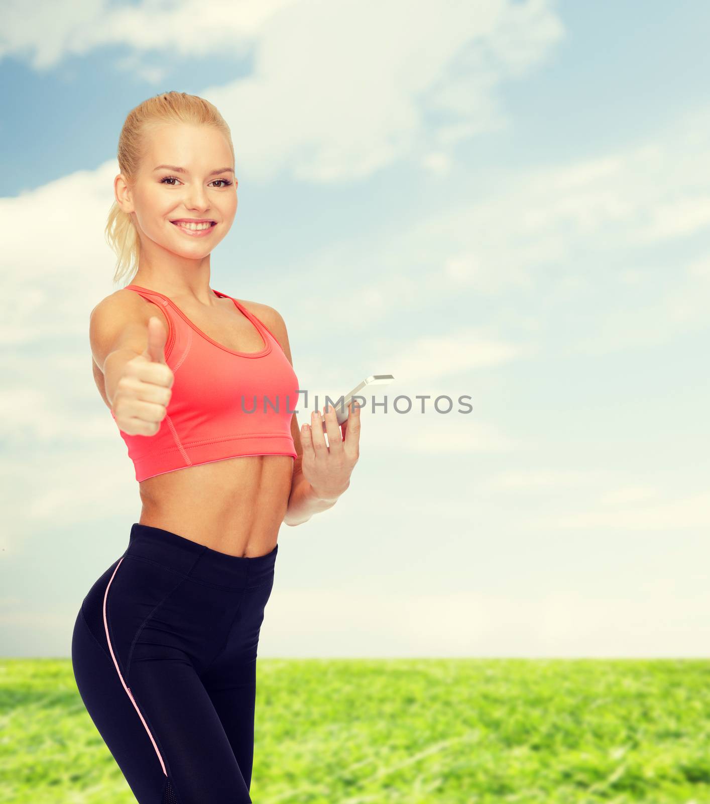 sport, fitness, technology, internet and healthcare concept - smiling sporty woman with smartphone showing thumbs up