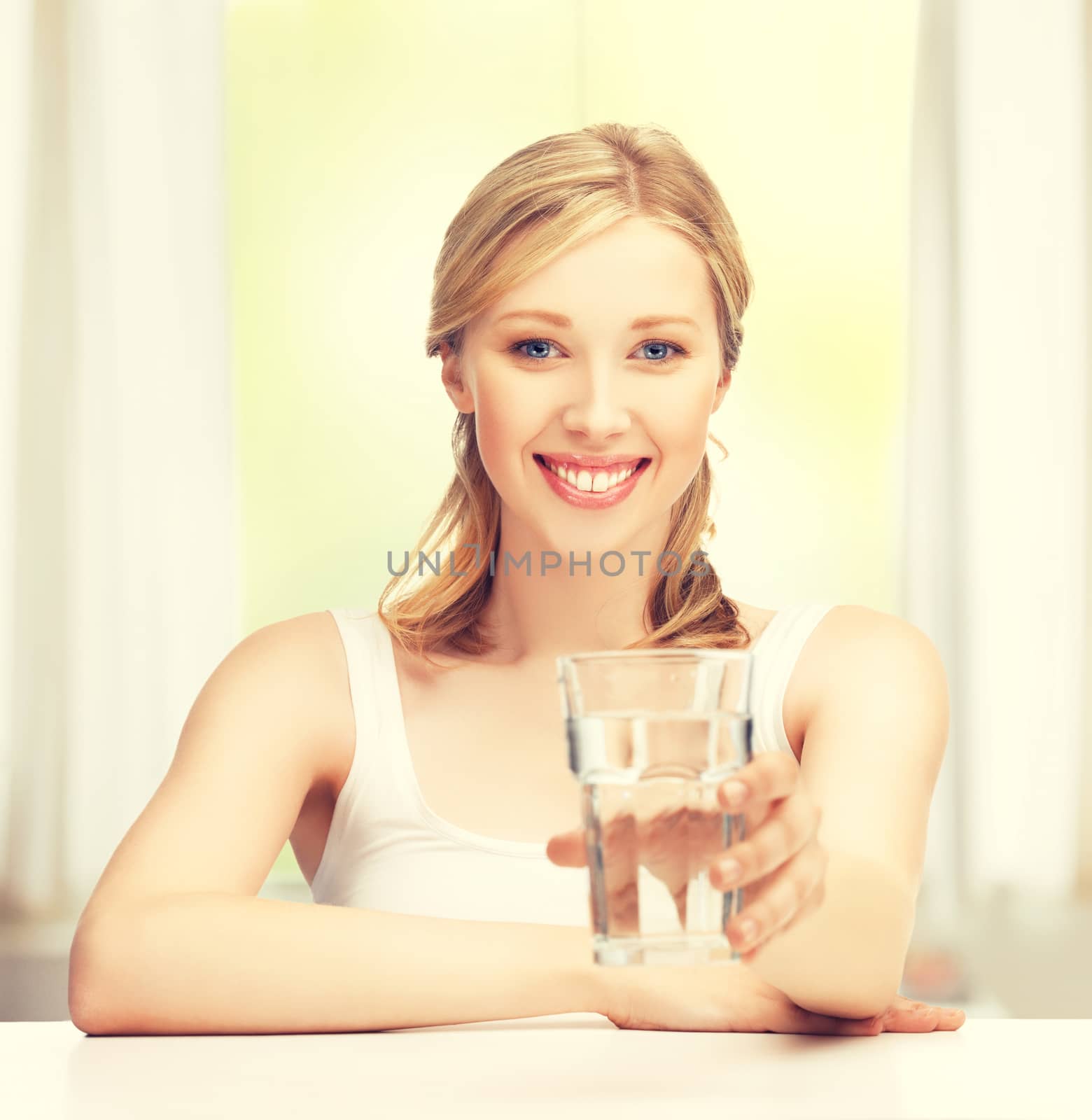 closeup of young smiling woman with glass of water