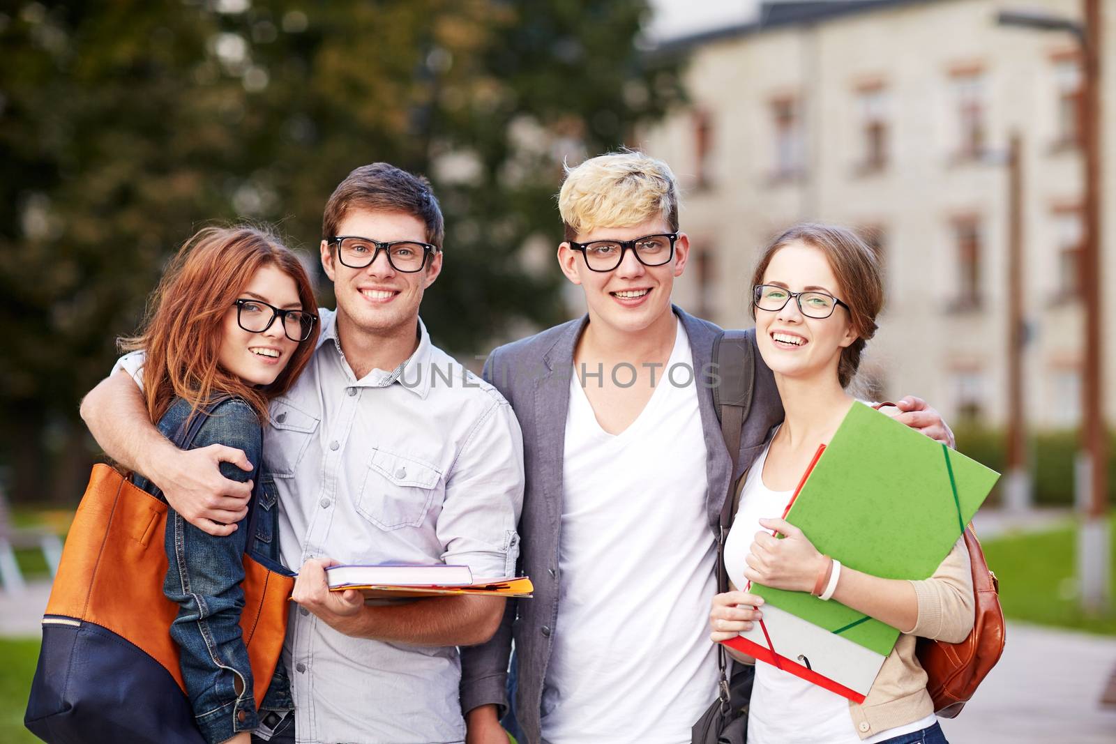 education, campus, friendship and people concept - group of happy teenage students with school folders