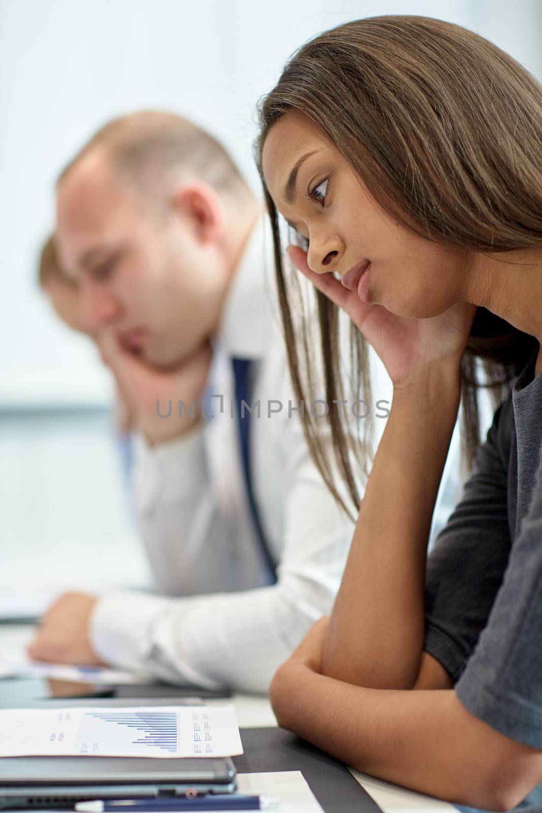 business, teamwork, people and crisis concept - business team sitting sad and solving problem in office