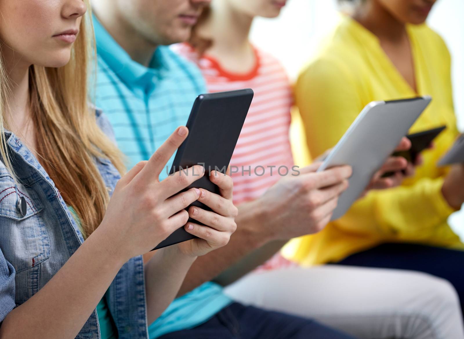 close up of students with tablet pc at school by dolgachov