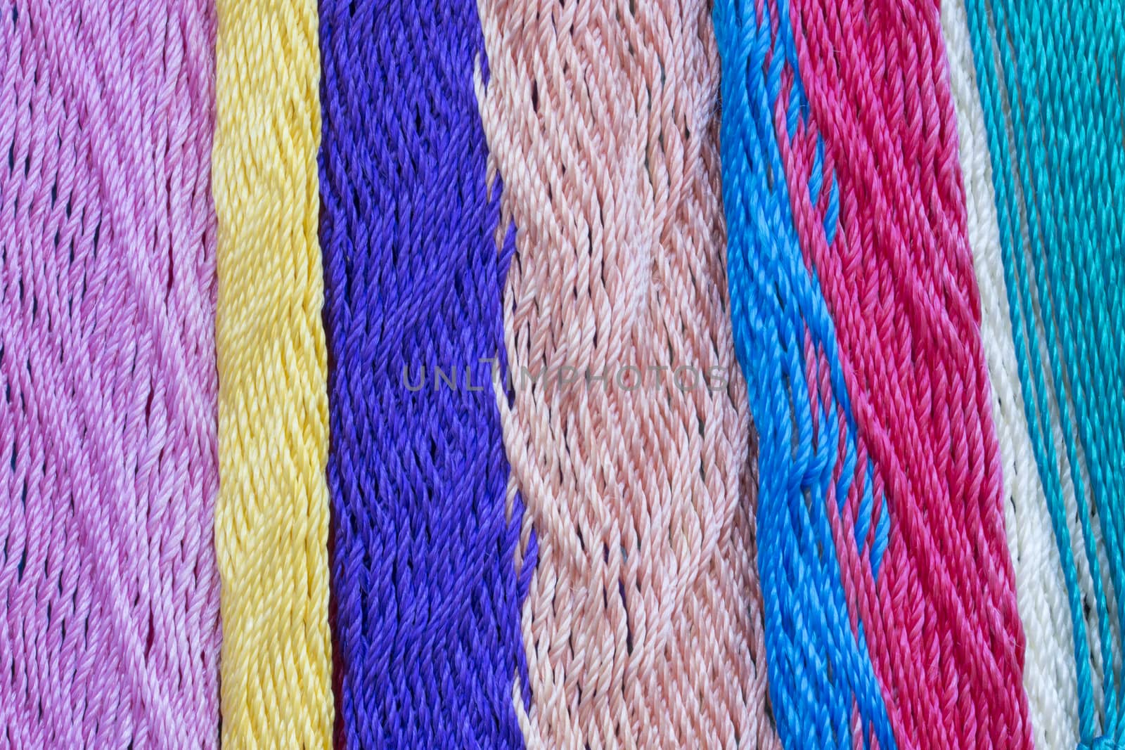 Macro closeup intricate nylon weave of multi-colored Mexican hammock