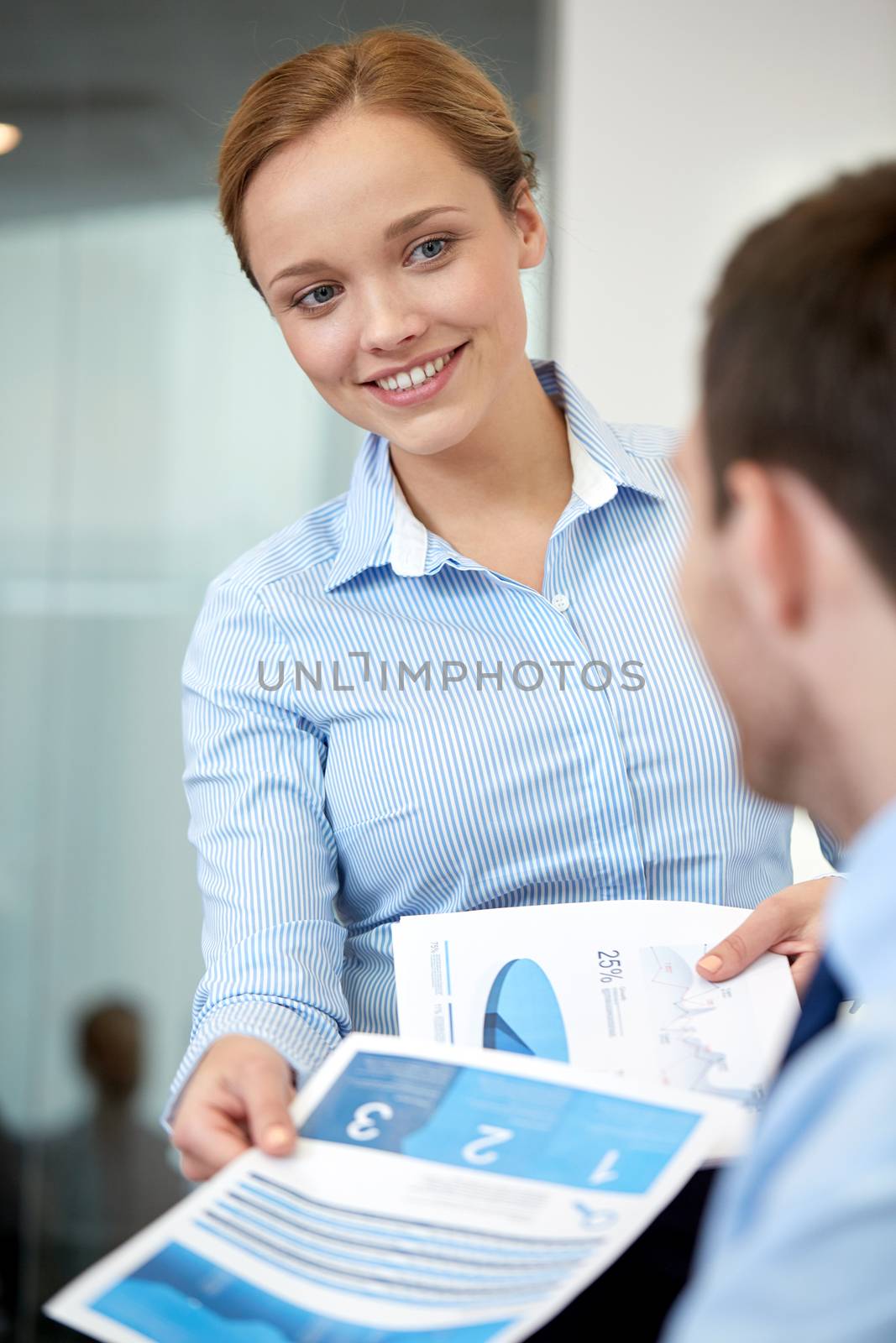 group of smiling businesspeople meeting in office by dolgachov