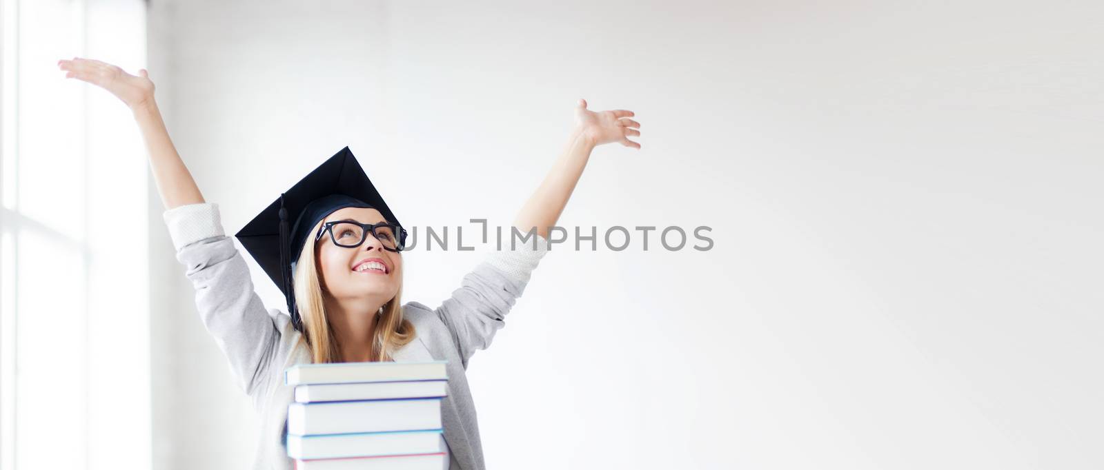 happy student in graduation cap by dolgachov