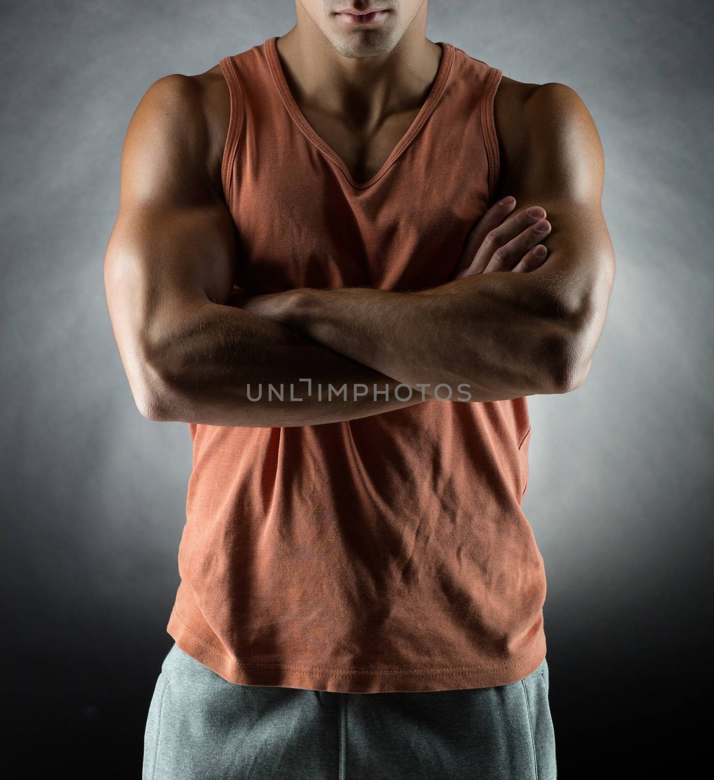 sport, bodybuilding, strength and people concept - young man standing over gray background