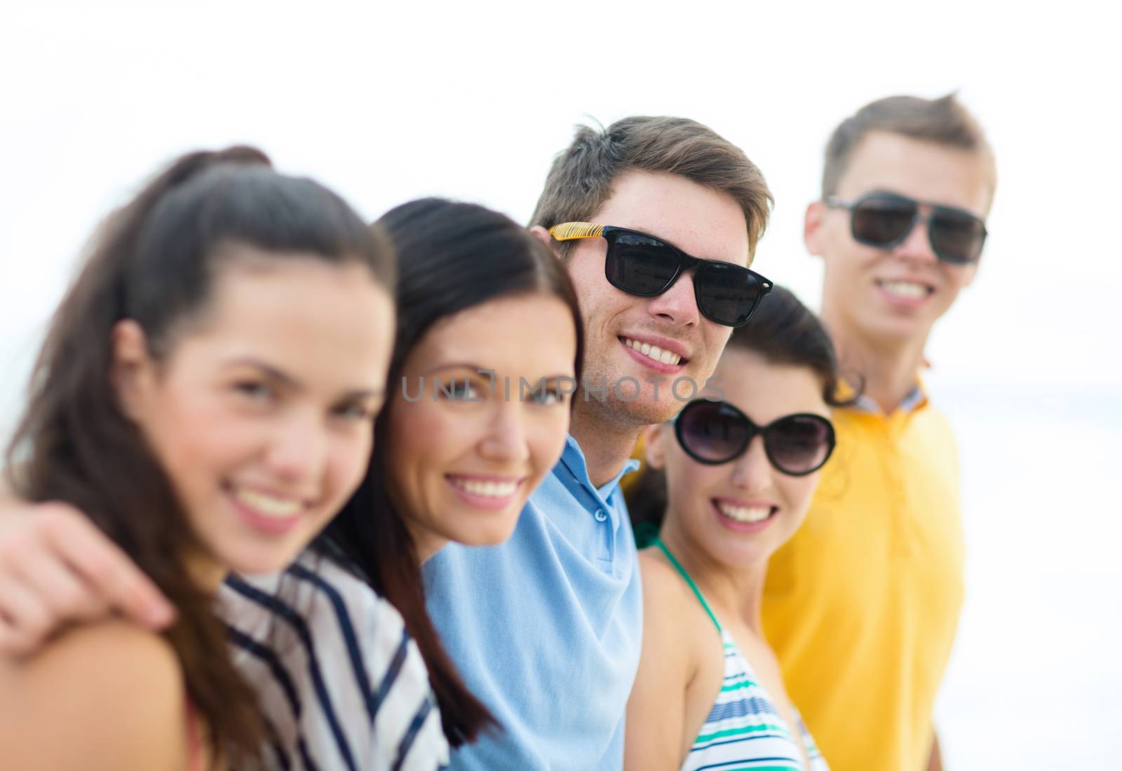 group of happy friends on beach by dolgachov