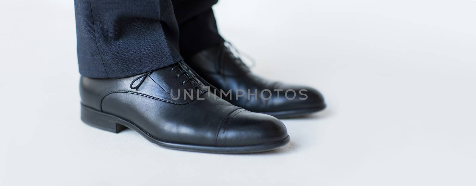 close up of man legs in elegant shoes with laces by dolgachov