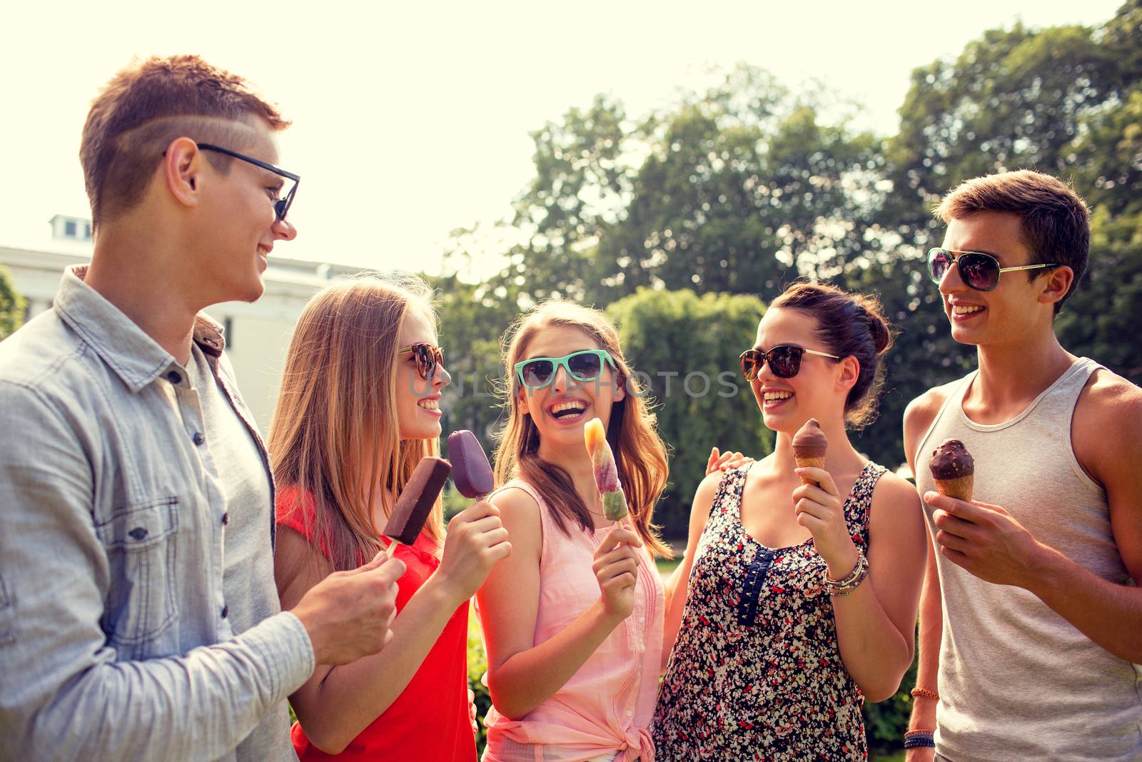 friendship, leisure, sweets, summer and people concept - group of smiling friends with ice cream outdoors