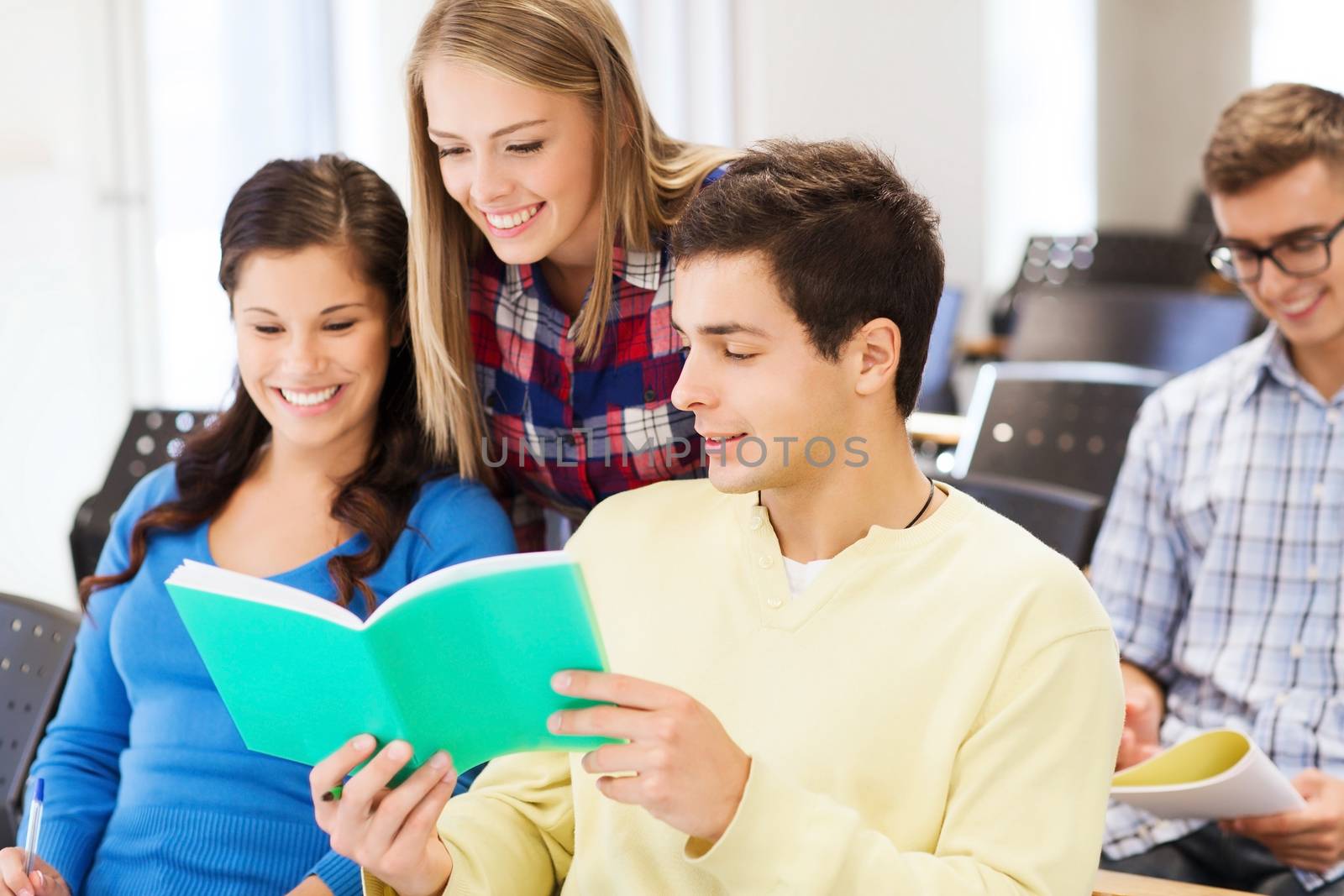 group of smiling students with notebooks by dolgachov
