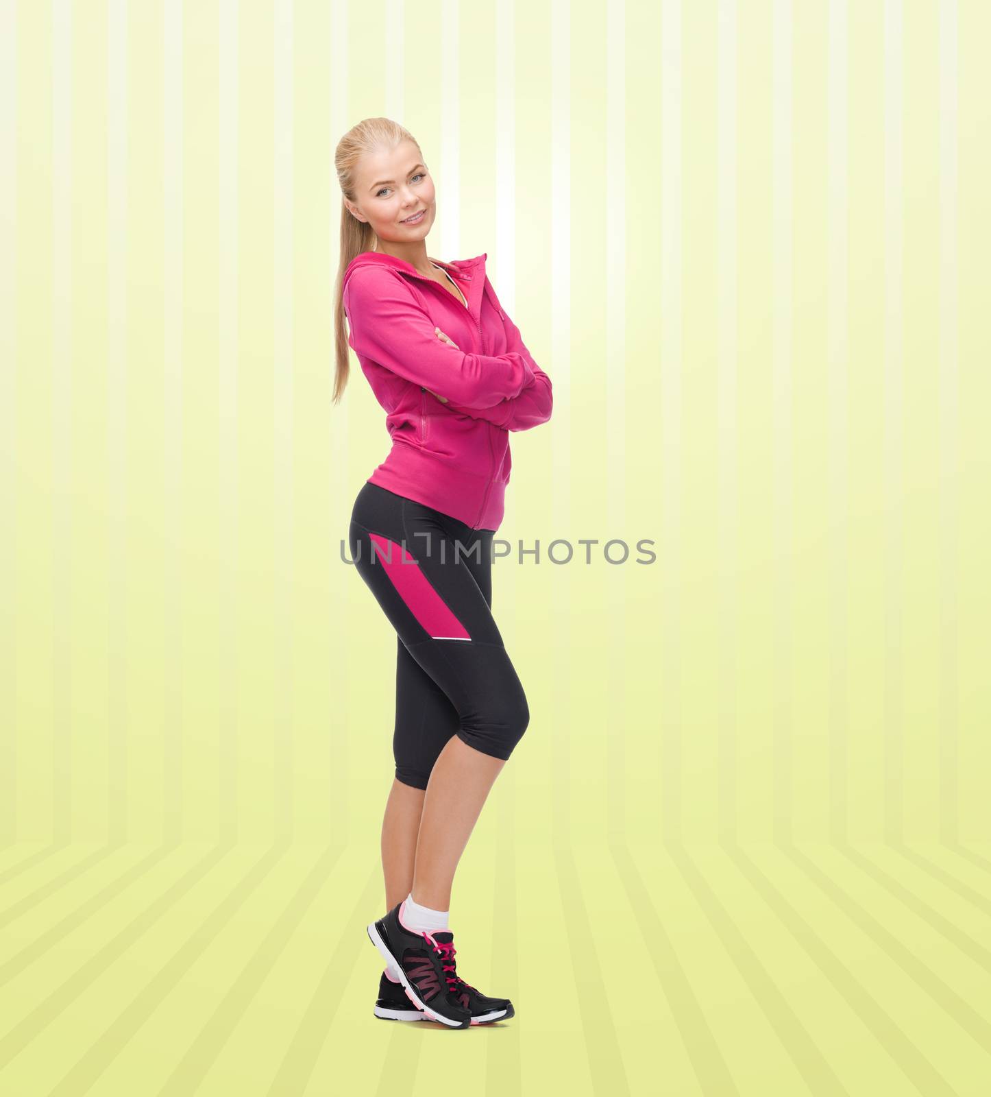 sport, fitness, people and weight loss concept - beautiful sporty young woman over yellow striped background