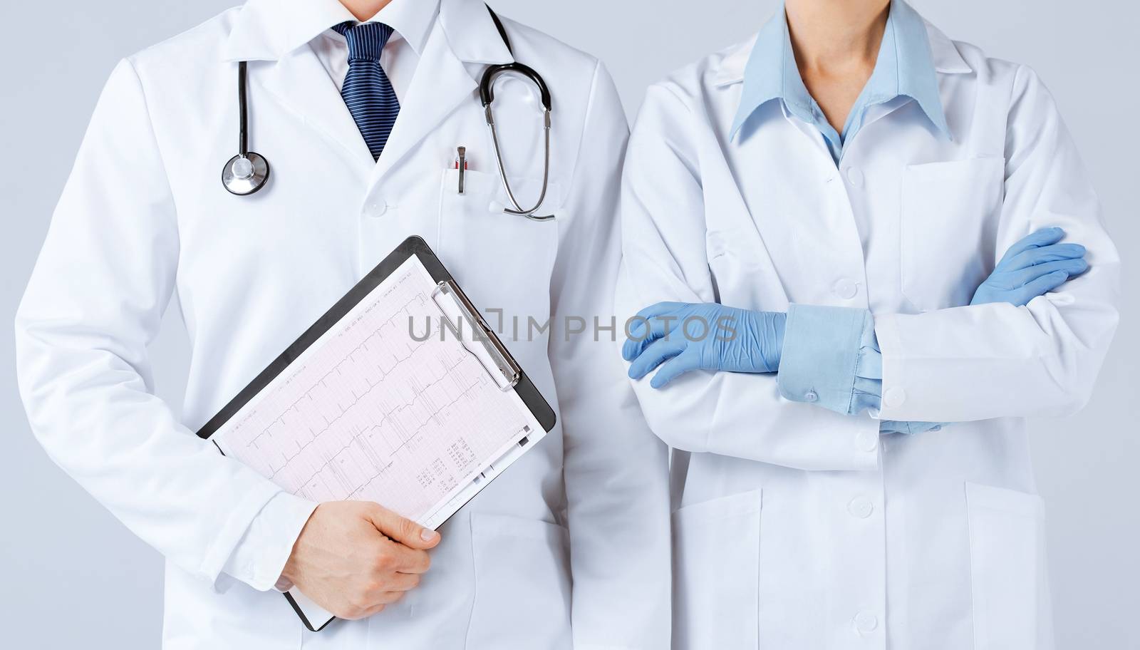 nurse and male doctor holding cardiogram by dolgachov