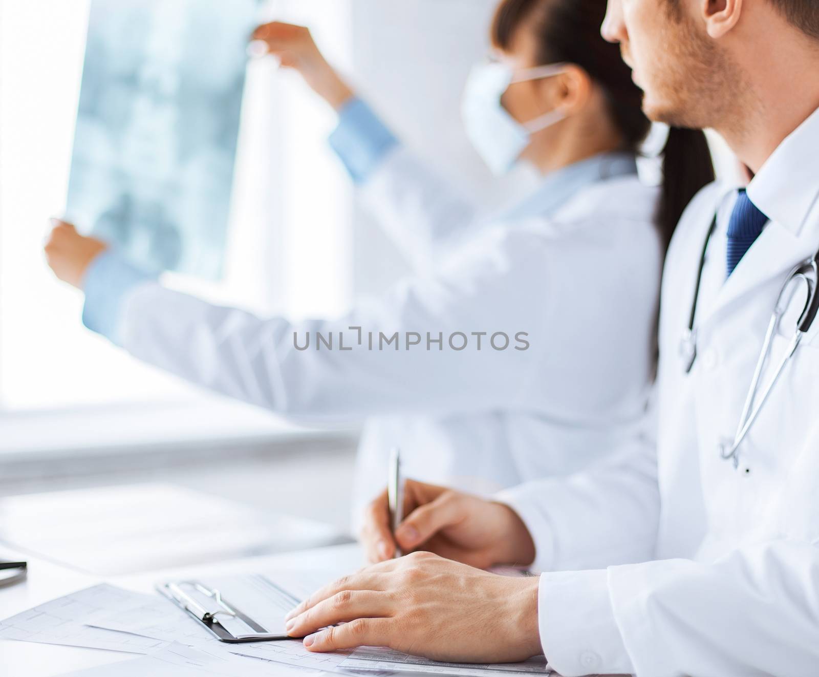 doctor and nurse exploring x-ray by dolgachov