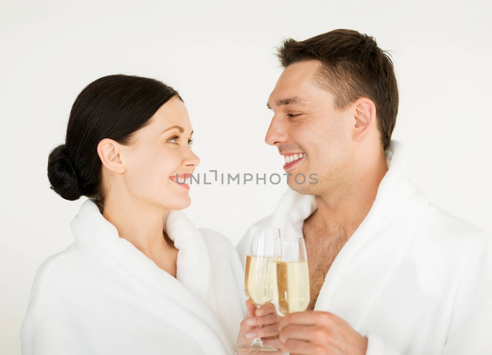 picture of couple in spa salon in white bathrobes with champagne