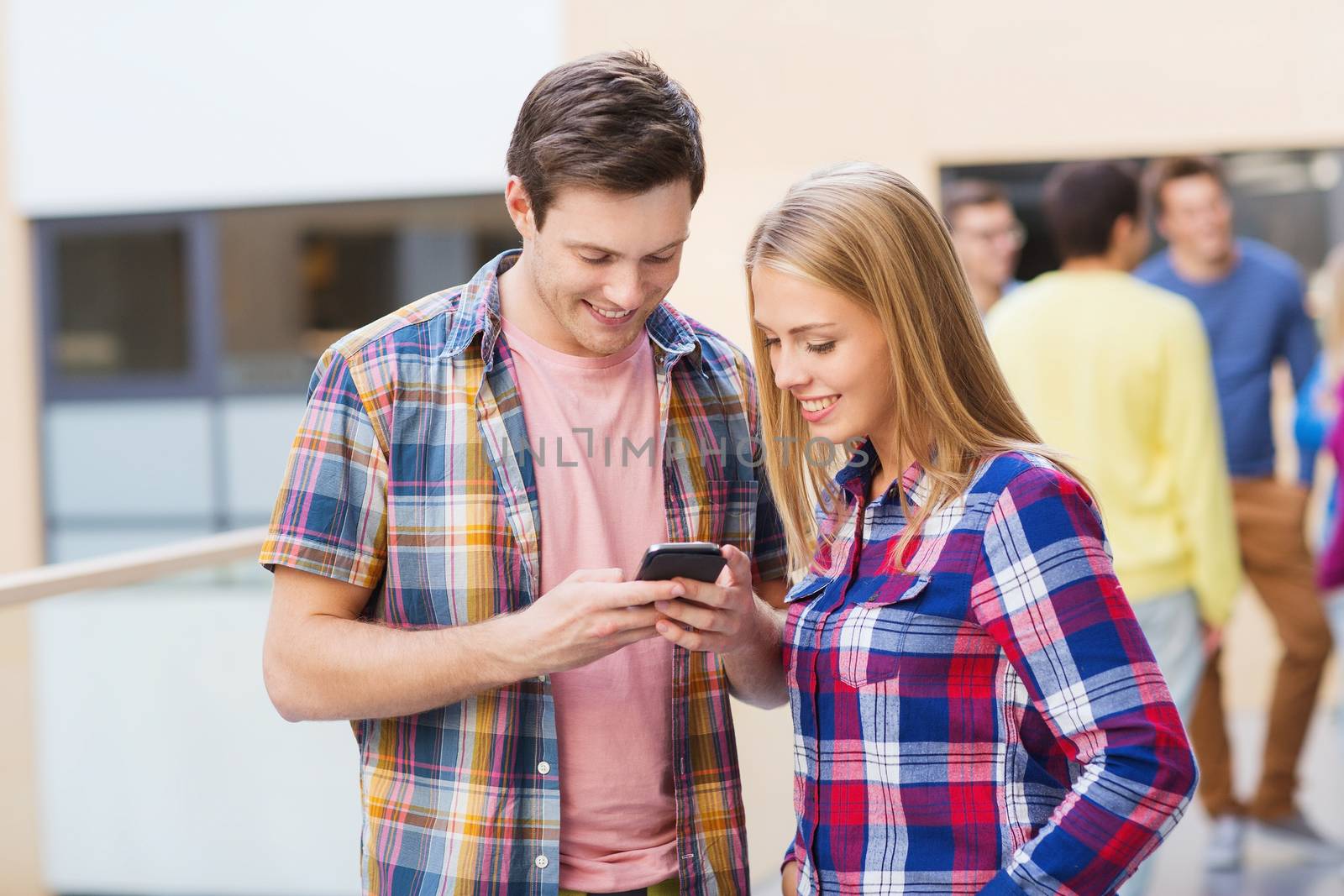 friendship, people, technology and education concept - group of smiling students with smartphone outdoors