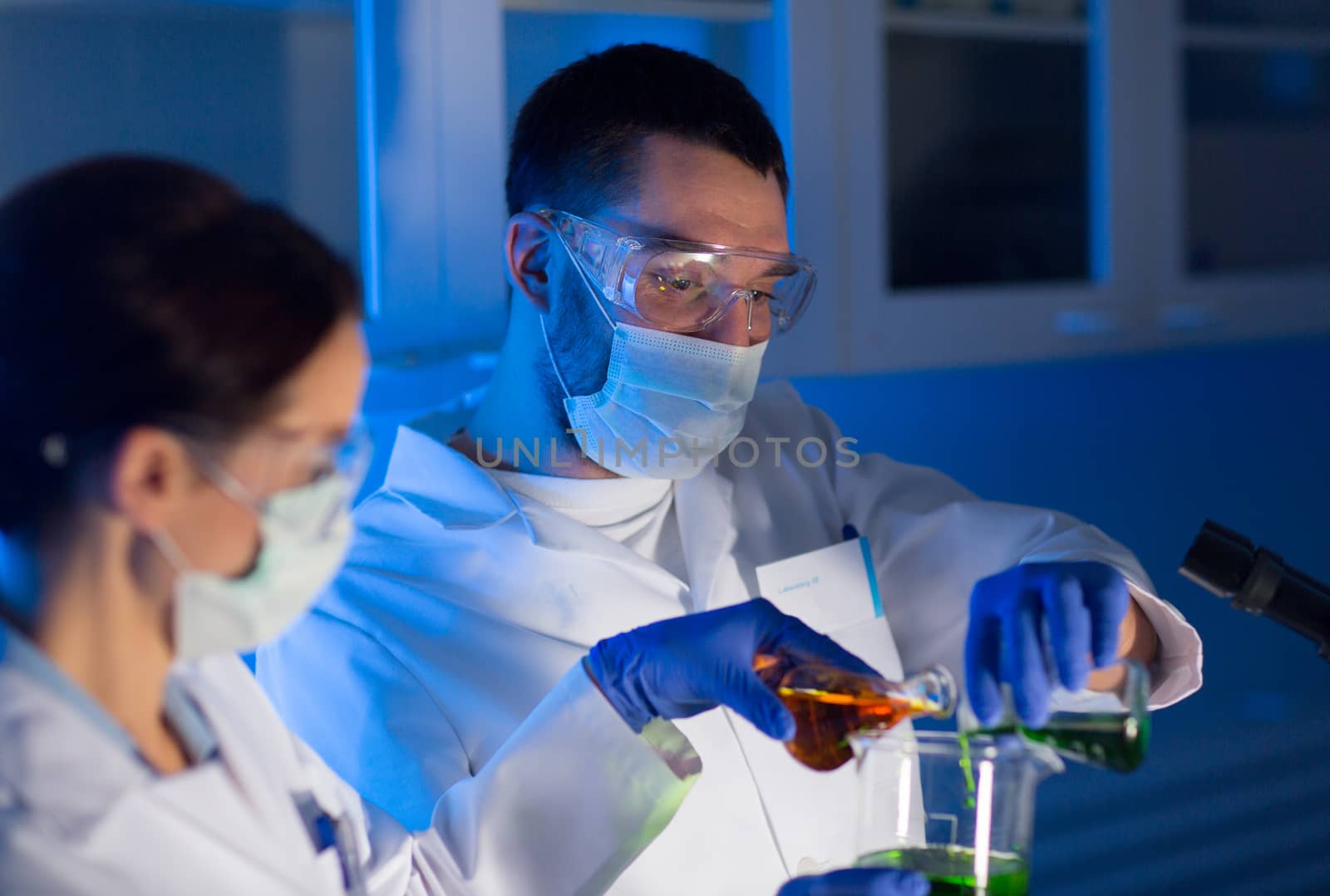 close up of scientists making test in lab by dolgachov