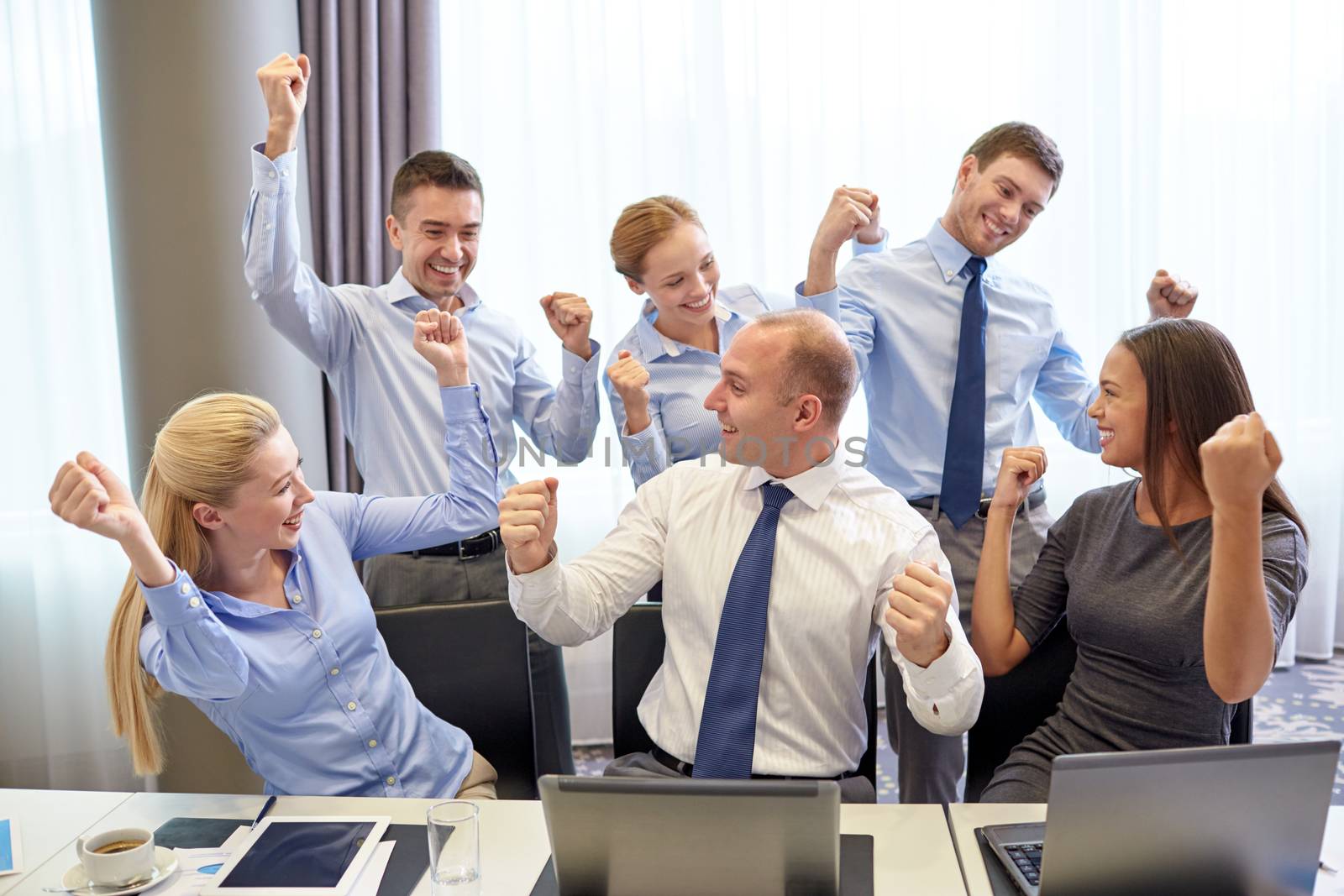 business people celebrating victory in office by dolgachov