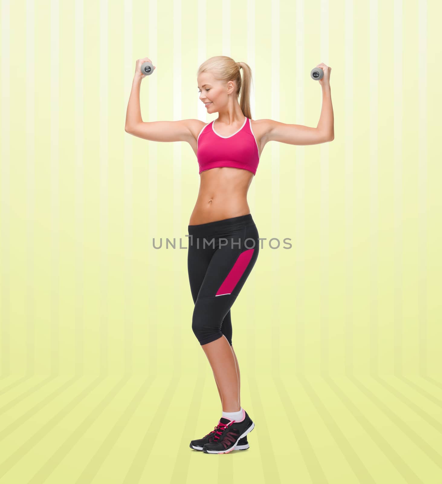 sport, fitness, training, weightlifting and people concept - young sporty woman with dumbbells flexing biceps over yellow striped background
