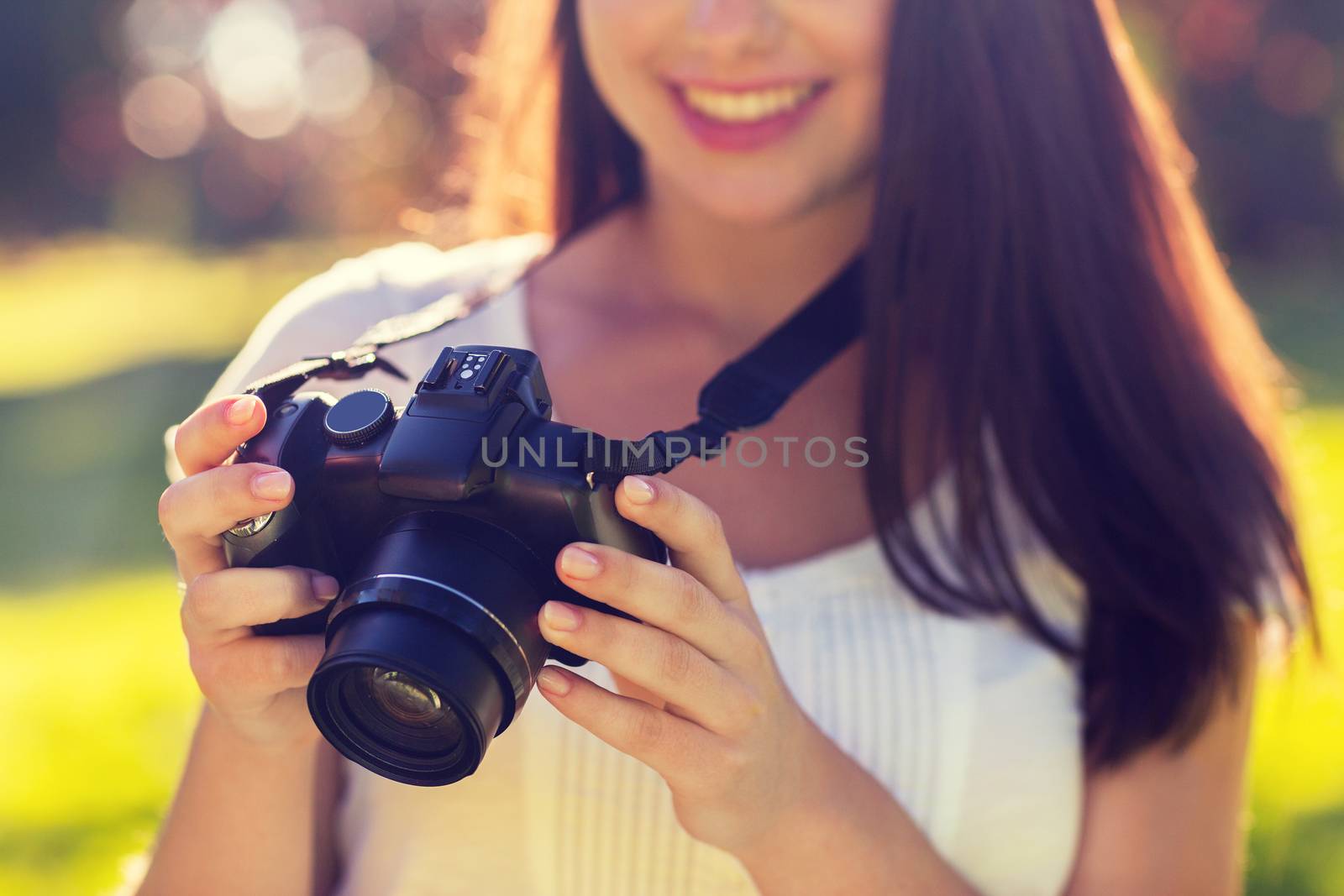 lifestyle, summer, vacation, technology and people concept - close up of young girl with photo camera outdoors