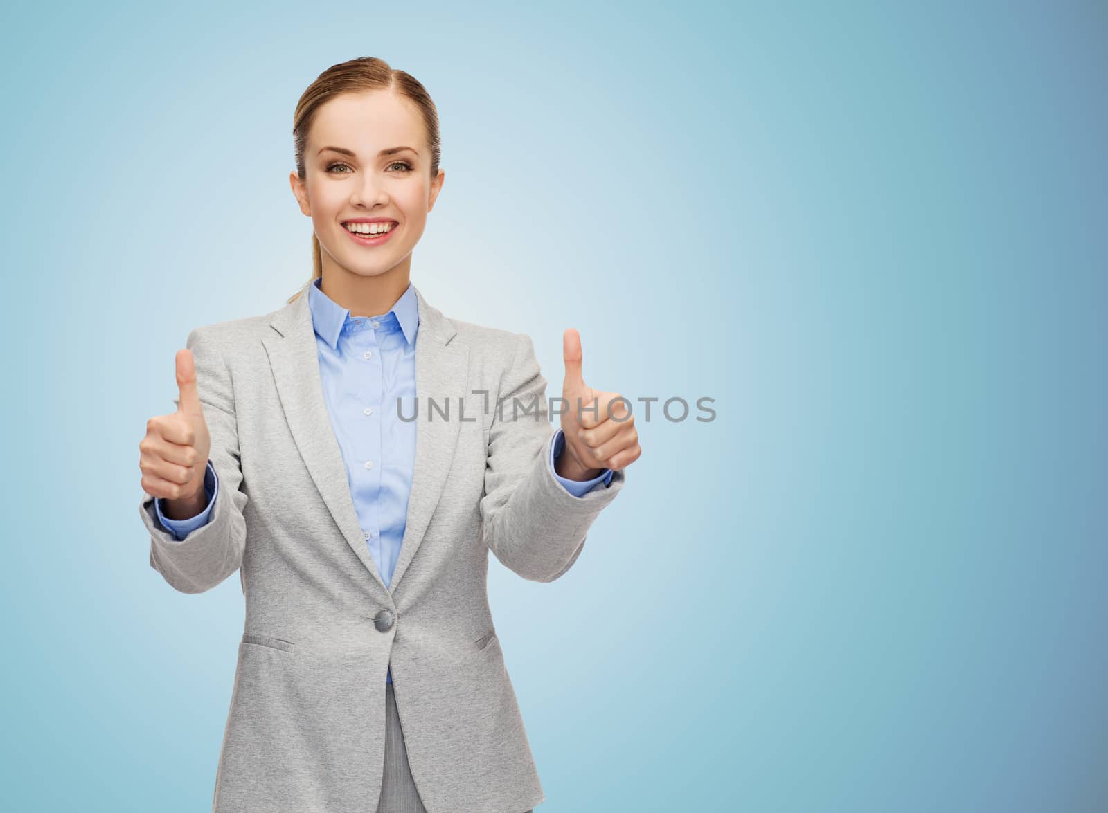 business, education, gesture and people concept - smiling businesswoman showing thumbs up over blue background