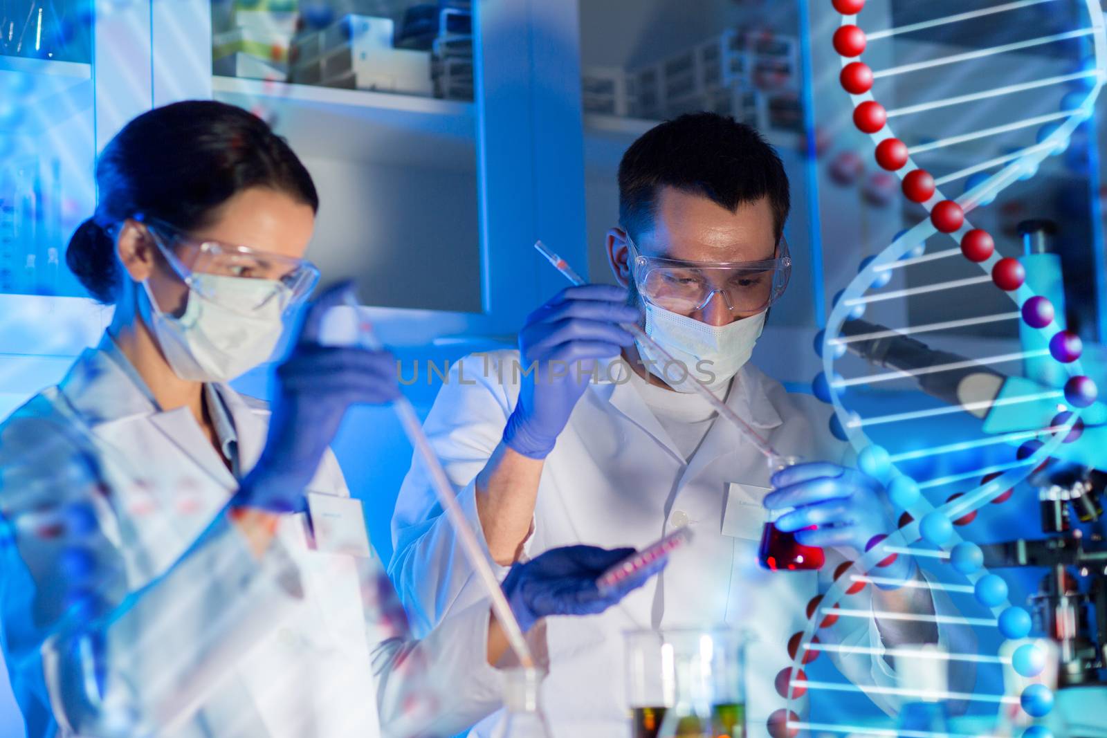 science, chemistry, biology, medicine and people concept - close up of young scientists with pipette and flasks making test or research in clinical laboratory over dna molecule structure