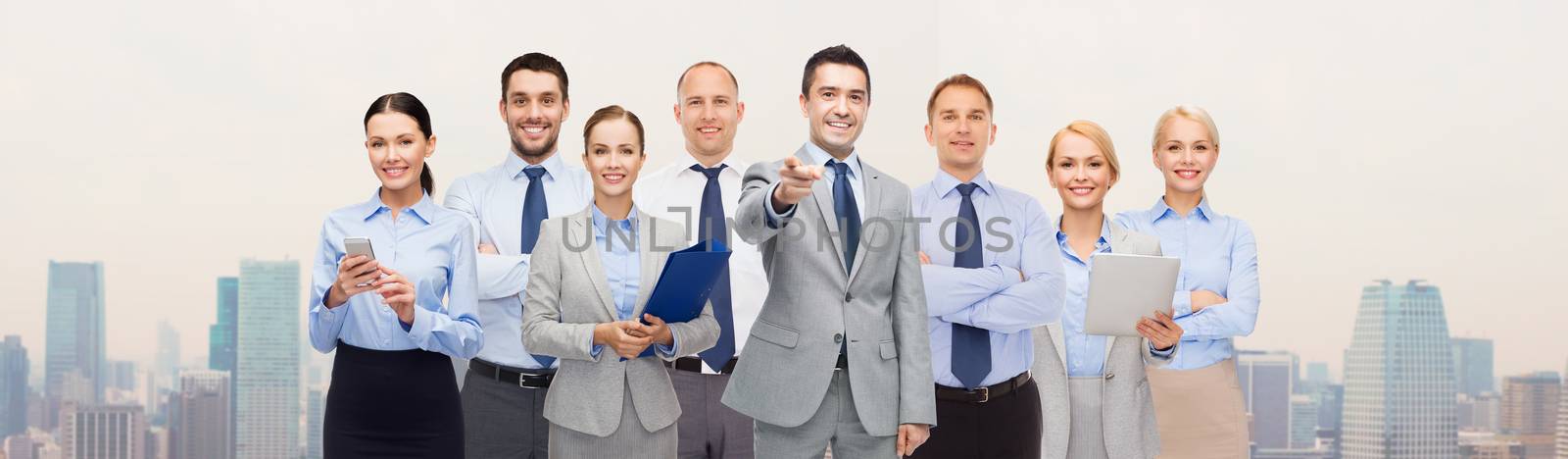 group of happy business people pointing at you by dolgachov