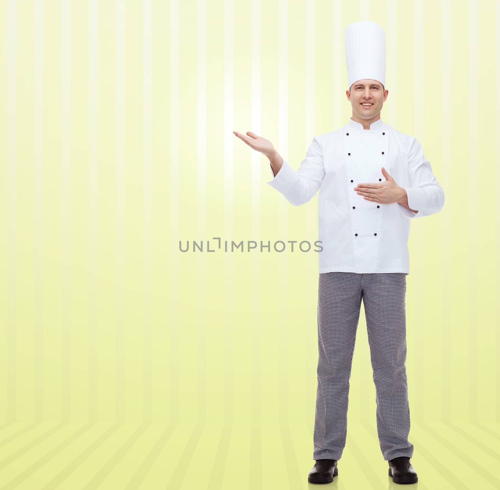 cooking, profession and people concept - happy male chef cook inviting over yellow background