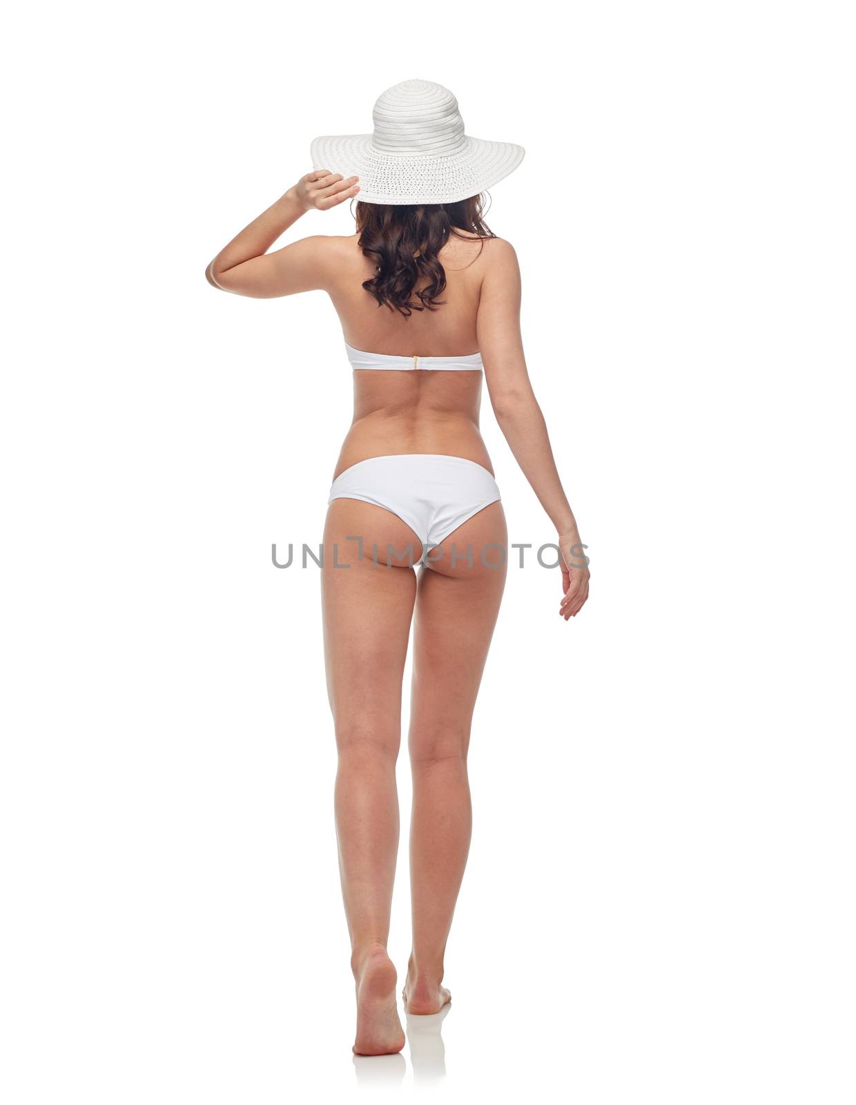 people, fashion, swimwear, summer beach and beauty concept - young woman in white bikini swimsuit from back