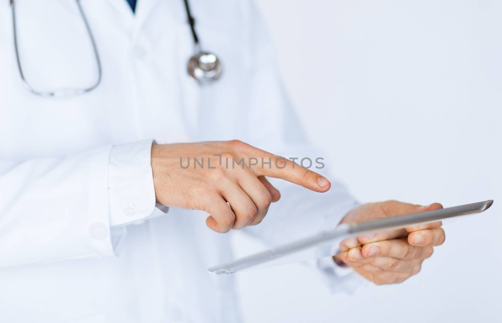 close up of male doctor holding tablet pc