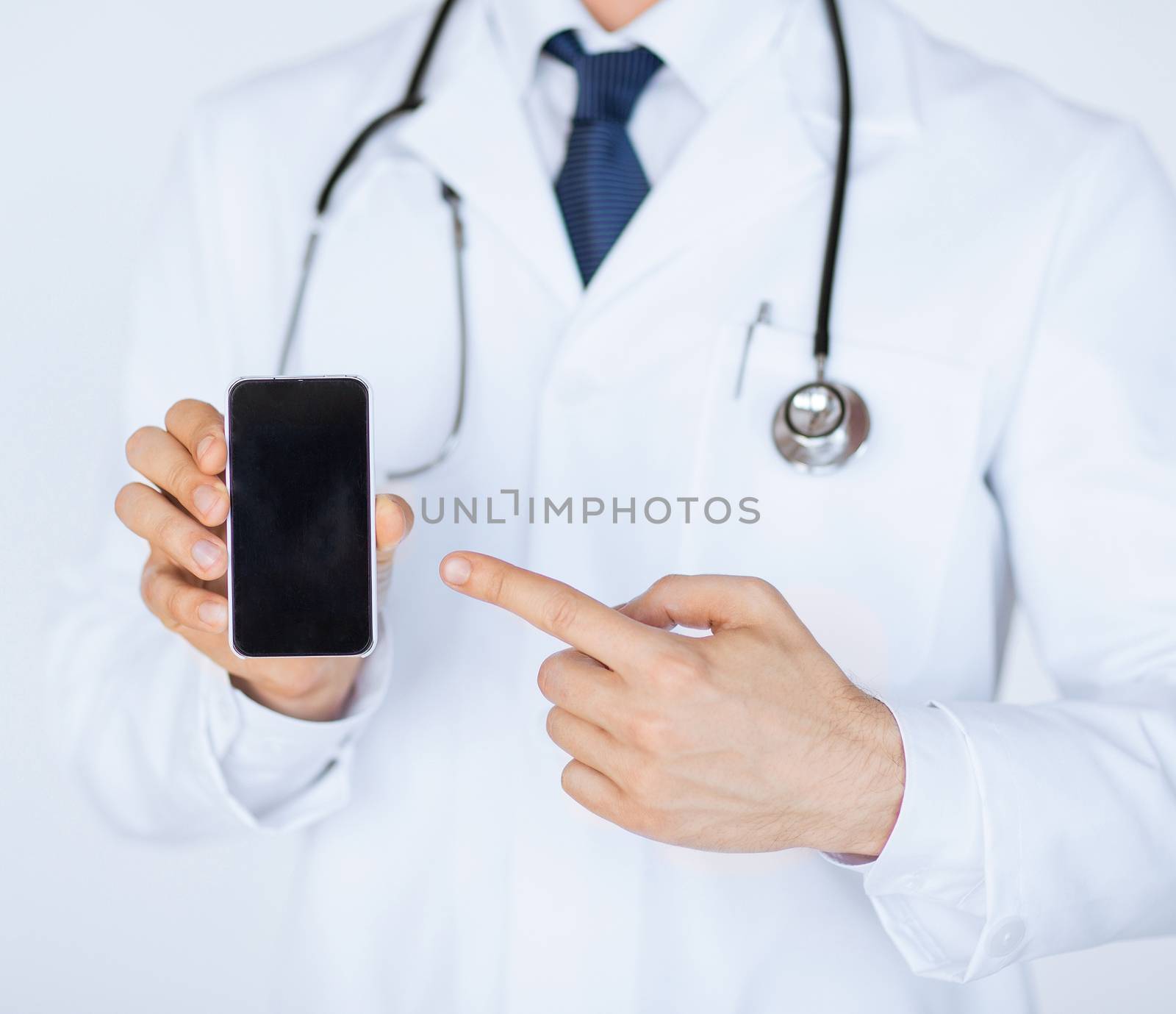 close up of male doctor pointing at smartphone