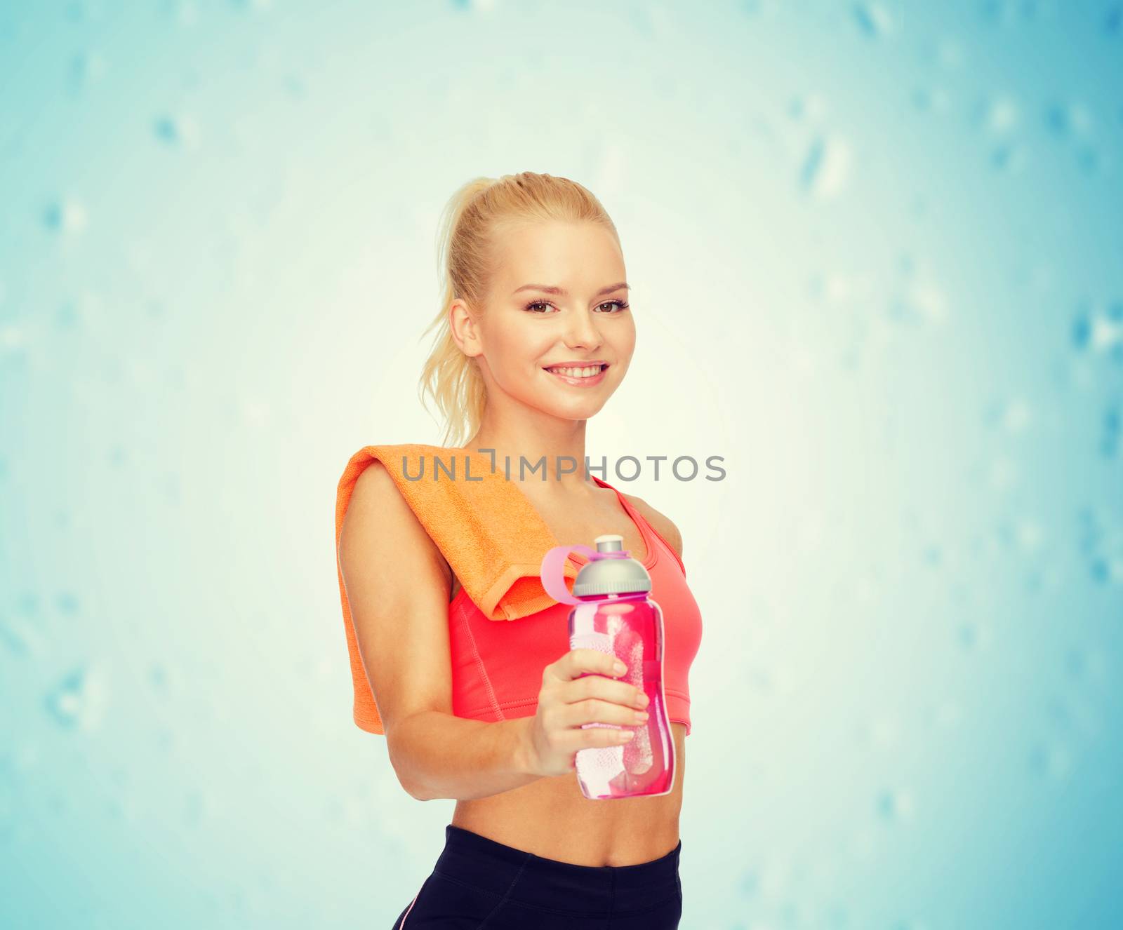 smiling sporty woman with water bottle and towel by dolgachov