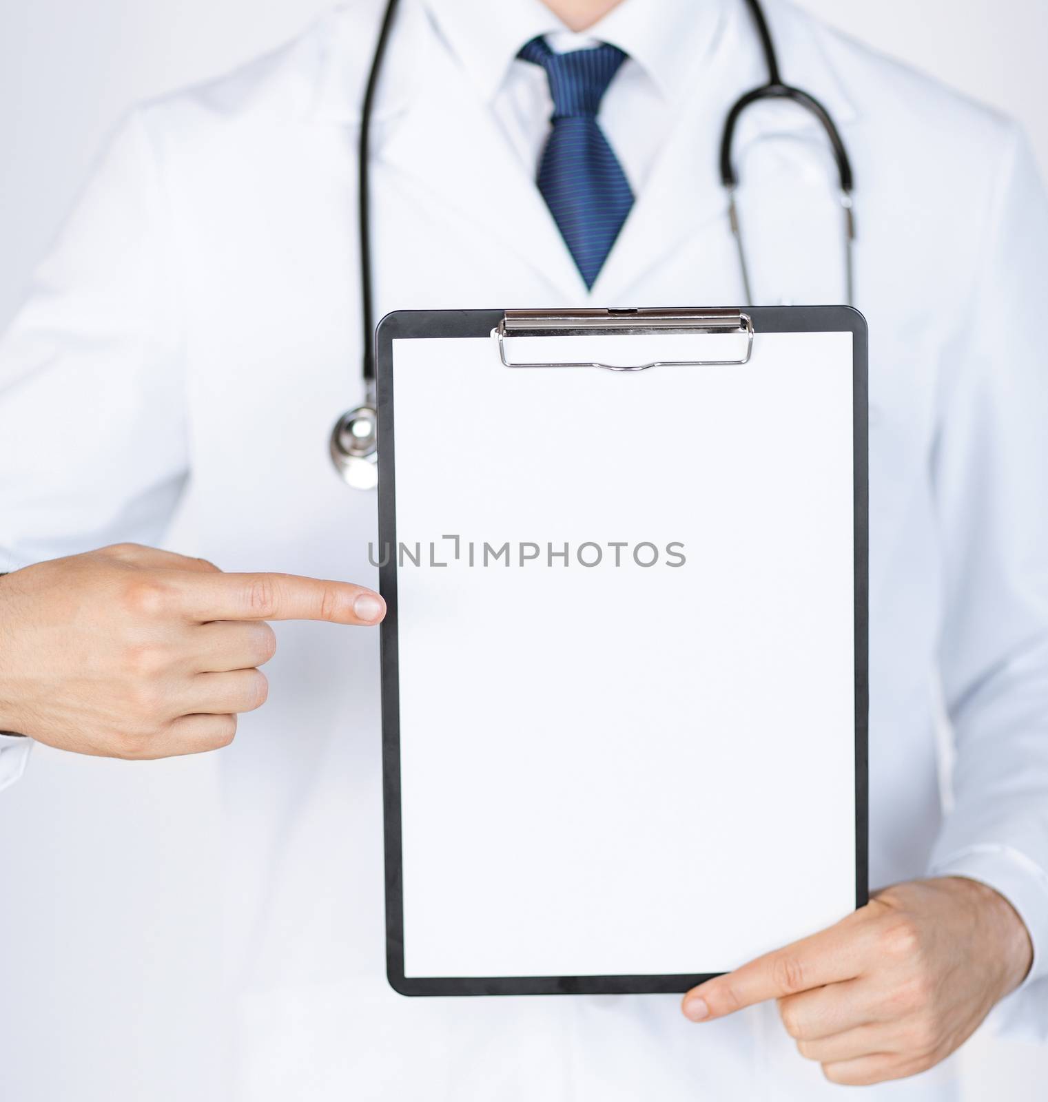 doctor pointing at blank white paper by dolgachov