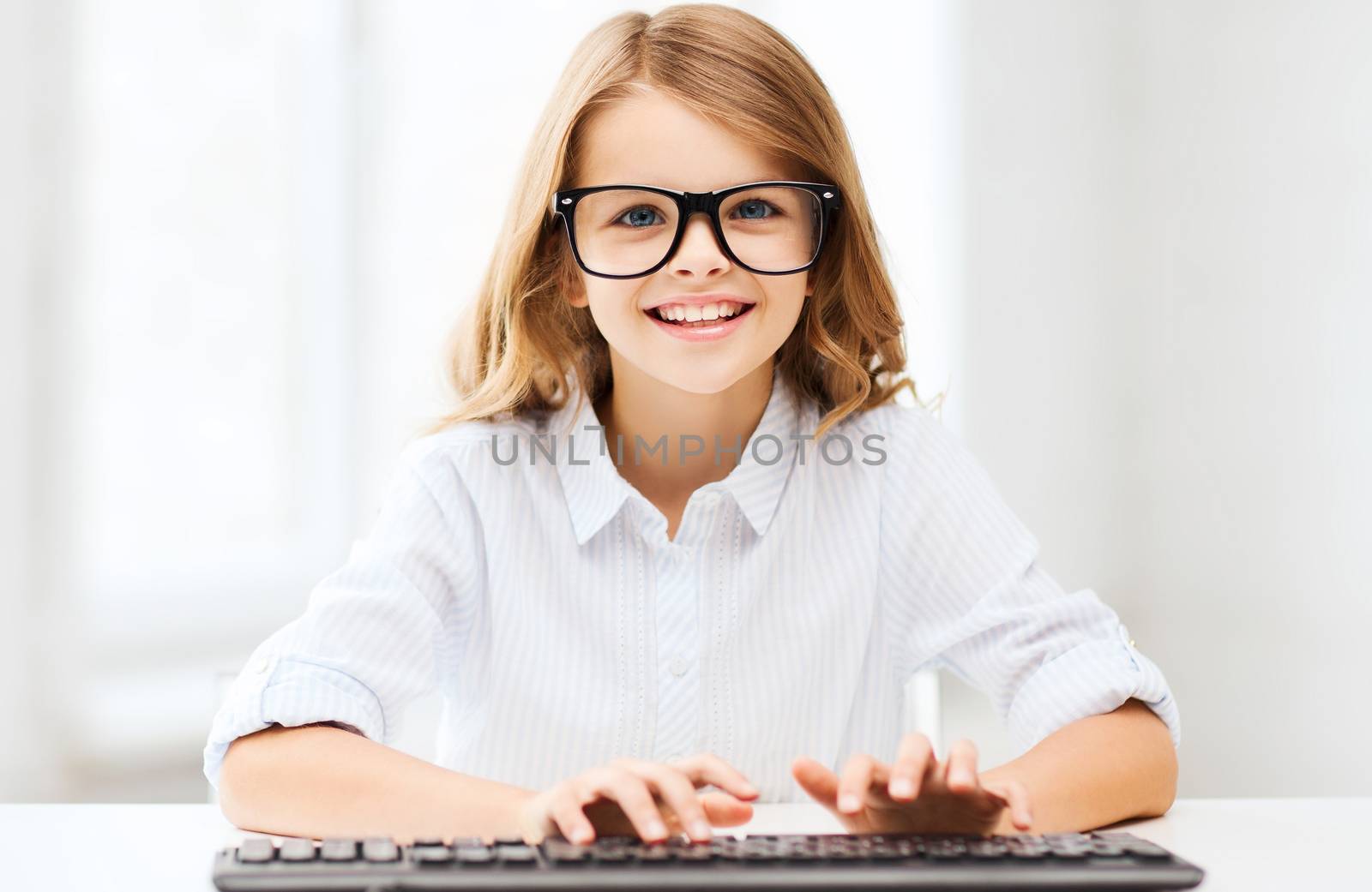 education, school and future technology concept - little student girl with keyboard and imaginary screen at school