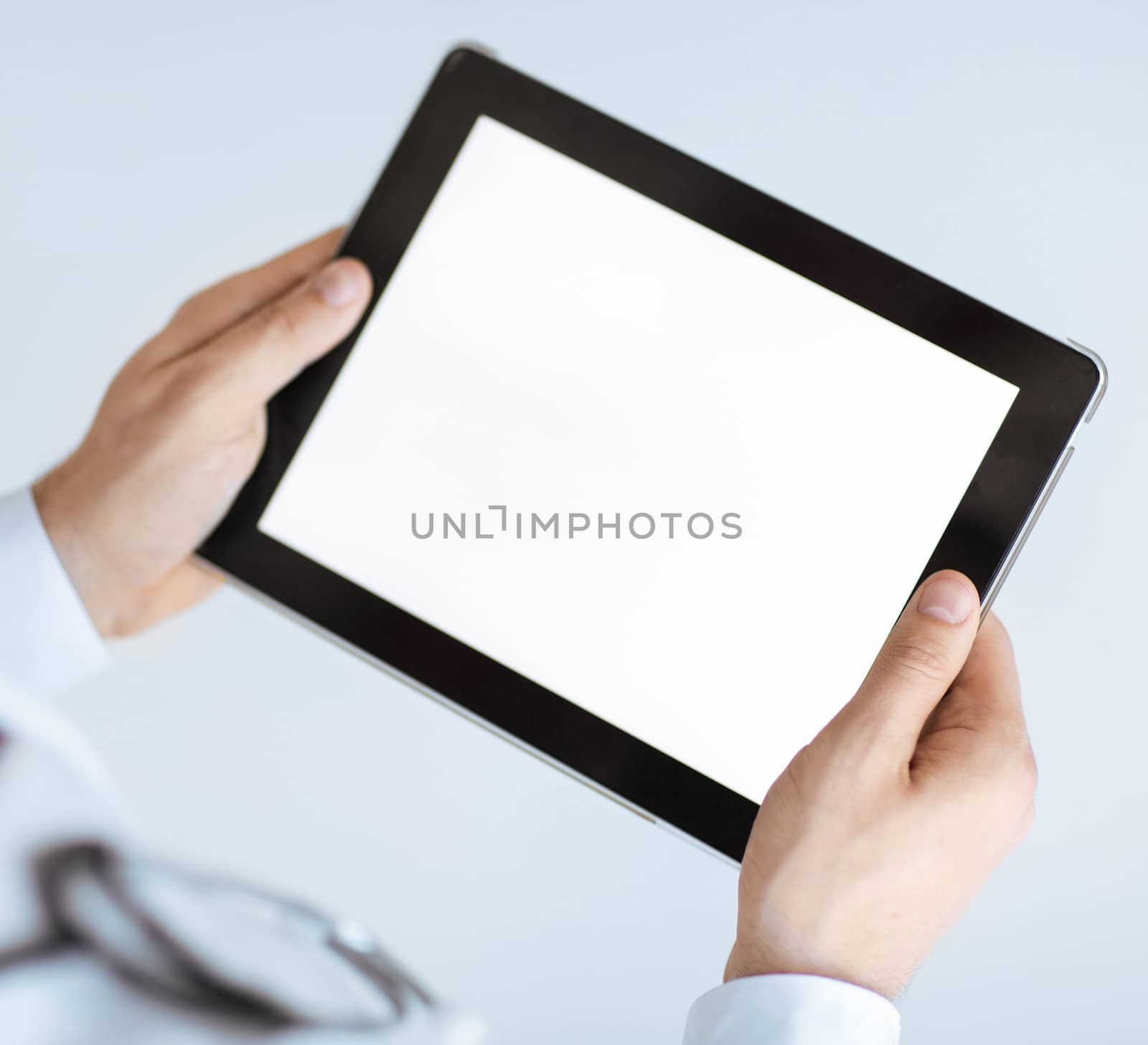 close up of male doctor hands holding tablet pc