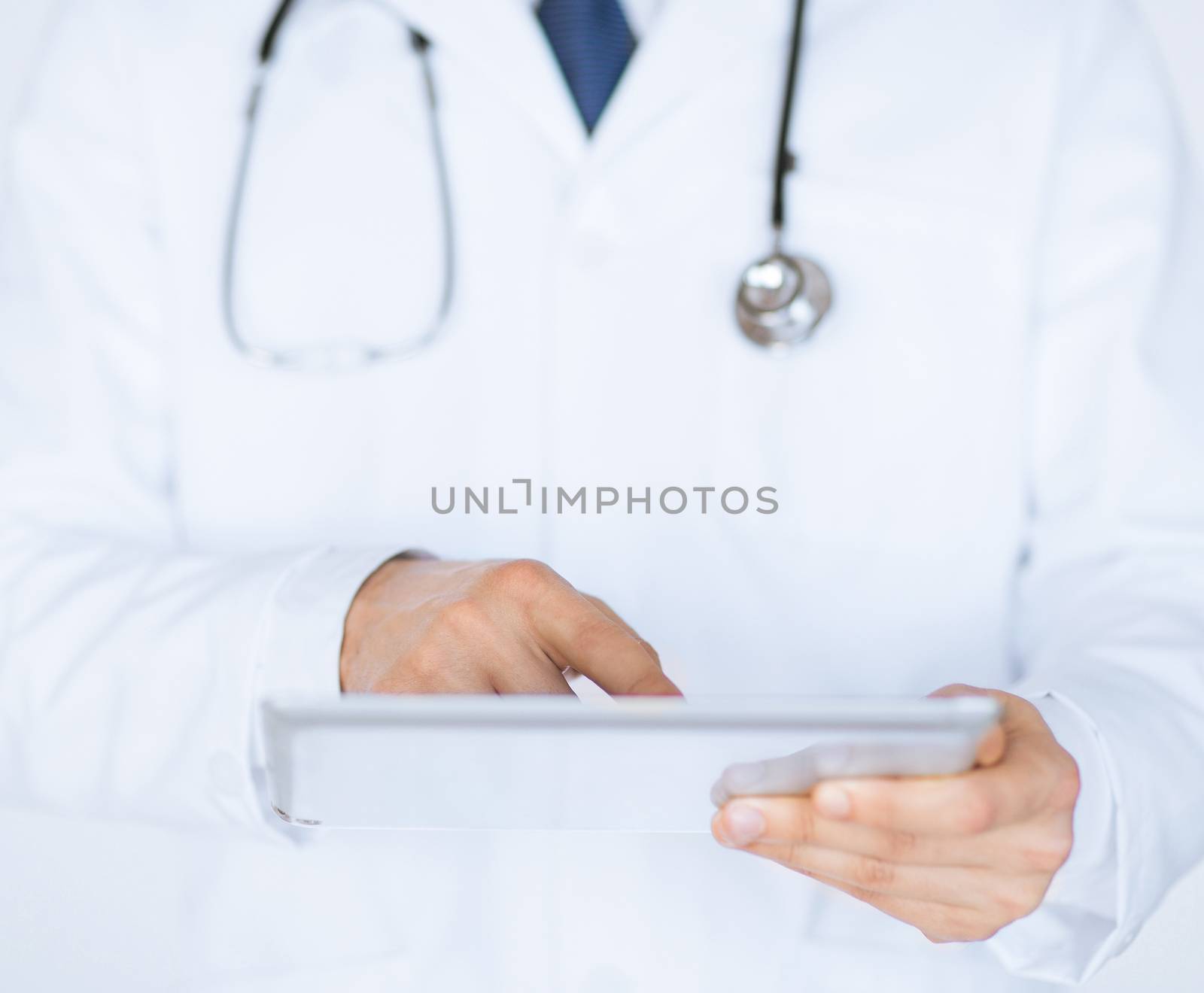 close up of male doctor holding tablet pc